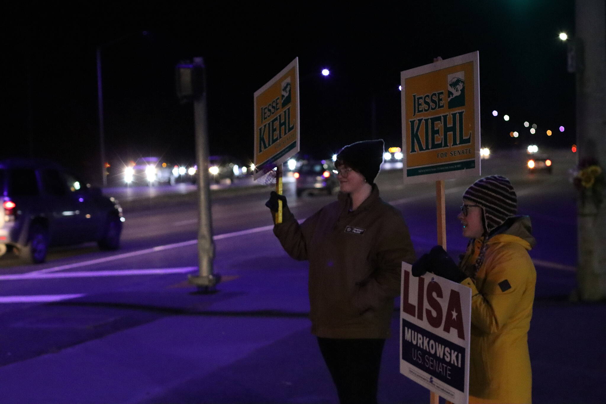 Ella Adkinson, left, and Cathy Schlingheyde are the lone campaign sign wavers during the evening rush hour at the McNugget Intersection, one of two major locations sign wavers typically gather locally. State Sen. Jesse Kiehl of Juneau, who coordinated some of the activity during the day, said nearly 20 people representing a variety of candidates gathered at the other intersection at Egan Drive and 12th Street at about 5 p.m. By 6 p.m. all of them were gone from the downtown intersection. (Mark Sabbatini / Juneau Empire)