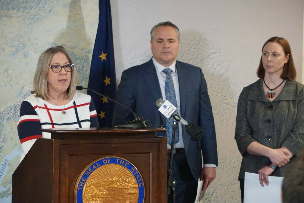 Alaska Attorney General Treg Taylor, center, is seen at a March 2022 news conference featuring Alaska Division of Elections director Gail Fenumiai (left) and deputy attorney general Cori Mills (right). A group that lists Taylor as a director has published a series of scathing attack ads in the last days before the general election. (Photo by Yereth Rosen / Alaska Beacon)