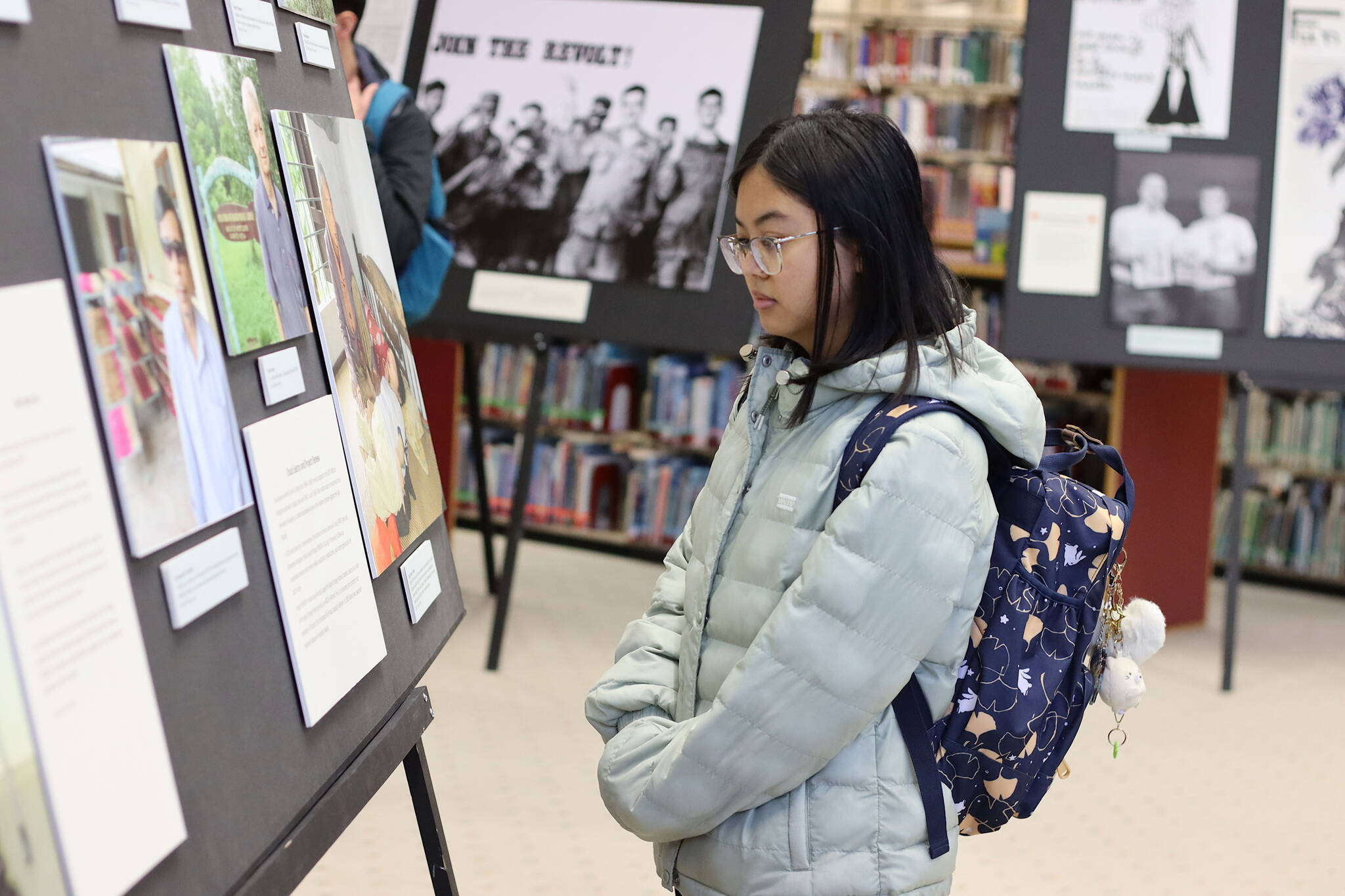 Mark Sabbatini / Juneau Empire 
Charlene Zanoria, a student at the University of Alaska Southeast, looks at part of the exhibit “Waging Peace In Vietnam: The Story of U.S. Soldiers and Veterans Who Opposed the War” during a preview event Thursday in the university’s library. The exhibit will officially be open from Friday through Dec. 15.