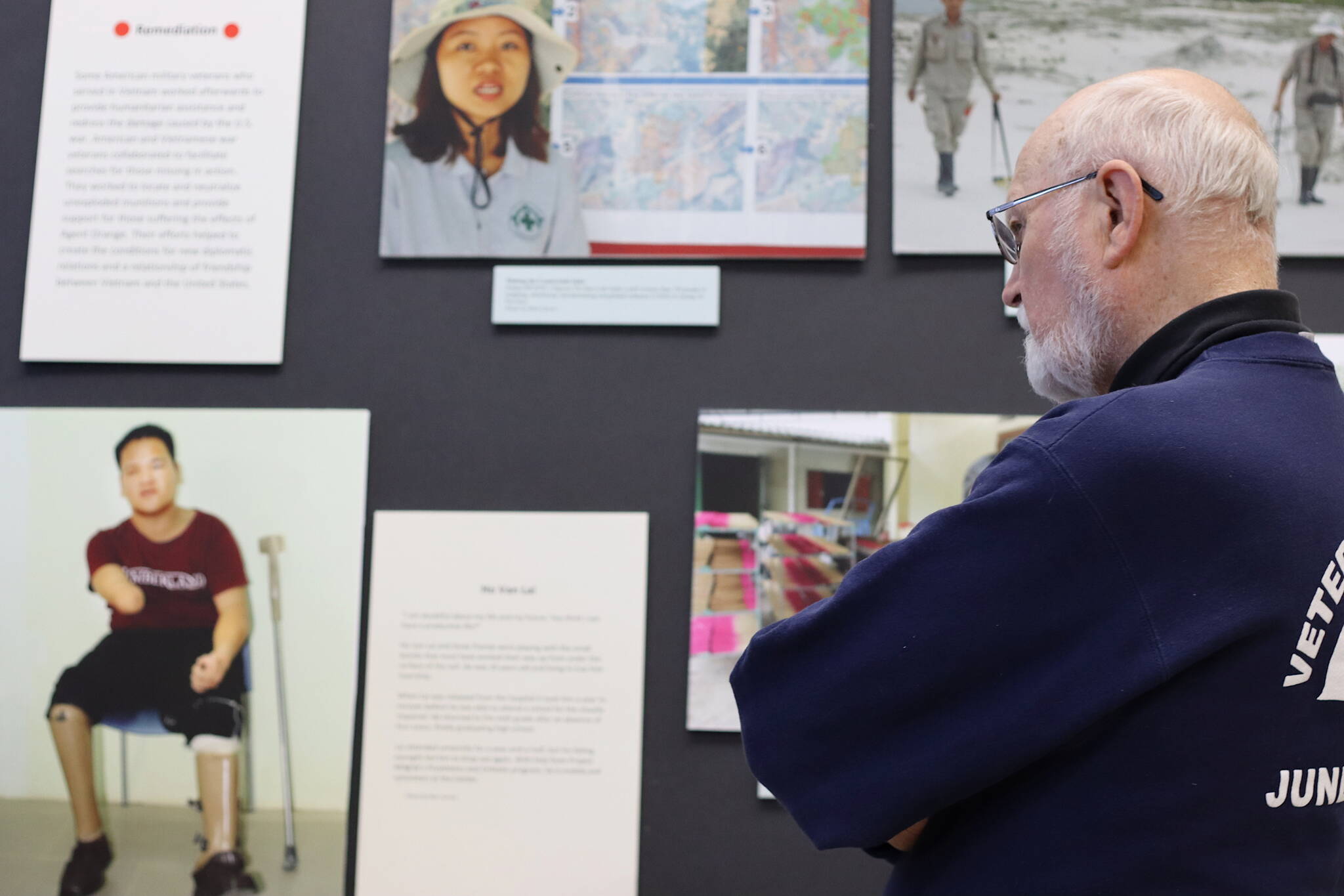 Mark Sabbatini / Juneau Empire 
Don Gotschall, a Juneau resident who served in the military during the Korean War, looks at a display featuring the stories of Vietnamese residents who lost limbs and suffered other injuries as a result of small bombs left by the U.S. during the Vietnam War. The display is part of the exhibit “Waging Peace In Vietnam: The Story of U.S. Soldiers and Veterans Who Opposed the War,” and organizers say there are still hundreds of thousands of such bombs scattered throughout Vietnam today.