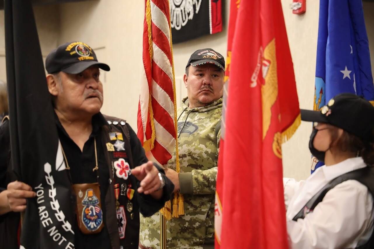 Roger Sheakley, a Tlingit Vietnam War veteran from Hoonah, holds a flag among other veterans at the Elizabeth Peratrovich Hall on Veterans Day Friday. A ceremony and luncheon were hosted in commemoration and honor of those who served and continue to serve in the U.S. military. (Clarise Larson / Juneau Empire)