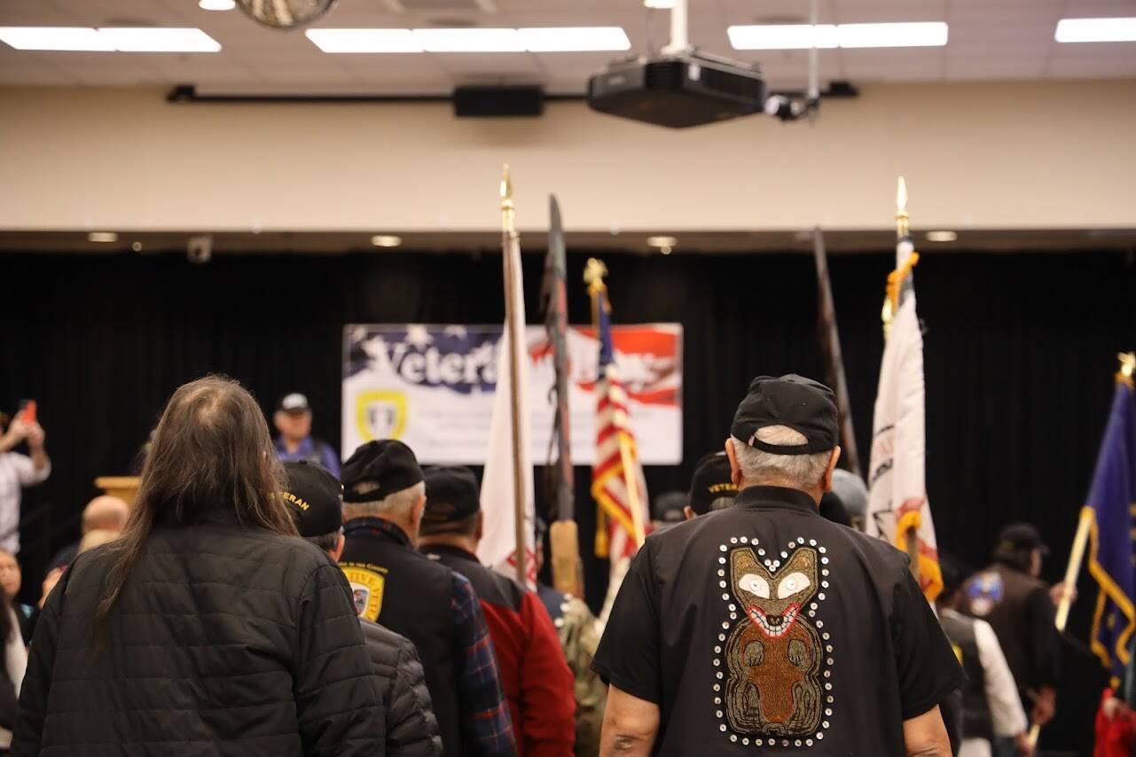 Southeast Alaska Native Veterans carry flags as they walk to the stage at the Elizabeth Peratrovich Hall on Veterans Day Friday. A ceremony and luncheon were hosted in commemoration and honor of those who served and continue to serve in the U.S. military. (Clarise Larson / Juneau Empire)