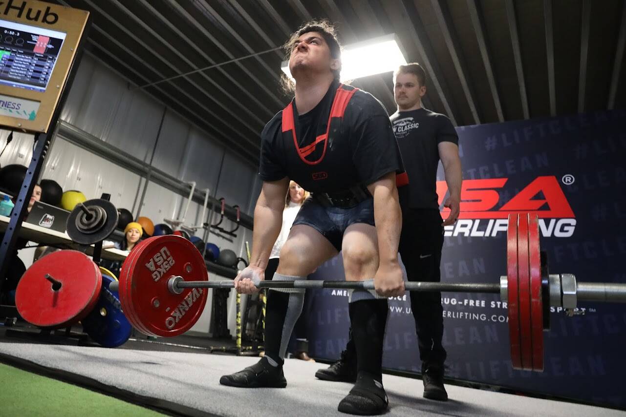 A competitor in the first-ever USA Powerlifting Coastal Clash competition hosted in Juneau starts his first round of deadlifting Saturday afternoon. (Clarise Larson / Juneau Empire)