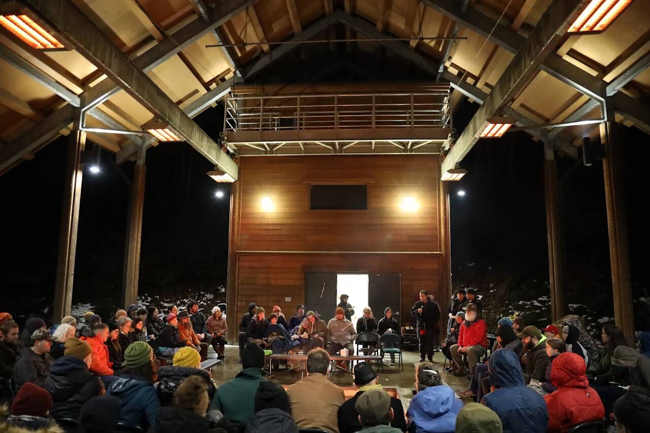 Clarise Larson / Juneau Empire 
More than 50 people sit on benches surrounding a fire pit that was used to conduct a traditional Tlingit fire dish ceremony in honor of late UAS professor Sol Neely, who died unexpectedly from a heart attack while backpacking last month.