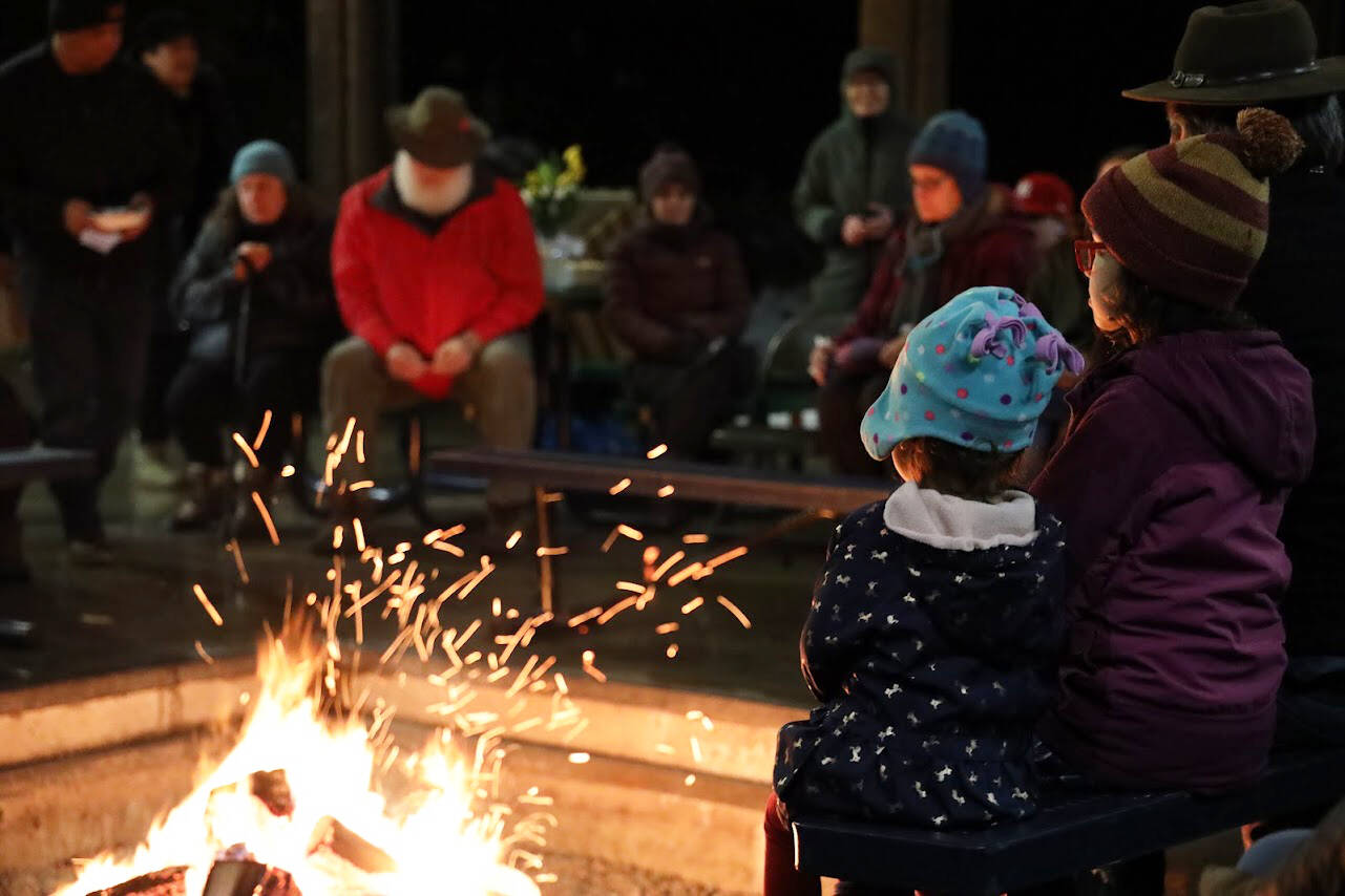 Clarise Larson / Juneau Empire 
Two young children face the flames of a fire at a celebration of life ceremony hosted at the University of Southeast Alaska’s Noyes Pavilion in honor of late UAS professor Sol Neely Saturday evening.