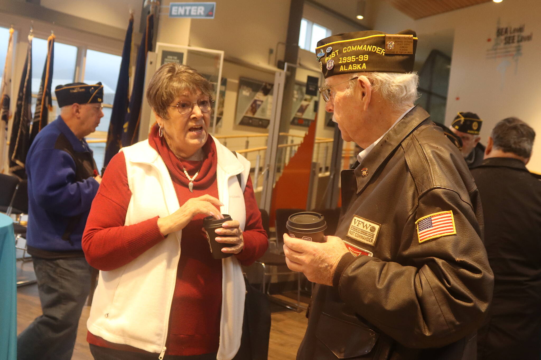 Donna Hurley and Tim Armstrong discuss the sinking of the USS Juneau during a reception Sunday at the Mount Roberts Tram terminal following a memorial ceremony commemorating the 80th anniversary of the vessel’s sinking. Both longtime Juneau residents are among those who’ve met some or all of the 10 survivors of the 697 soldiers aboard the ship. Hurley, who met survivors during a trip to the ship’s construction site in New Jersey, also made a string of remembrance beads with one pearl for each solider who was killed, plus other beads for noteworthy people associated with the ship. Armstrong introduced surviving members who served as grand marshals of the local Fourth of July parade in 1987. (Mark Sabbatini / Juneau Empire)