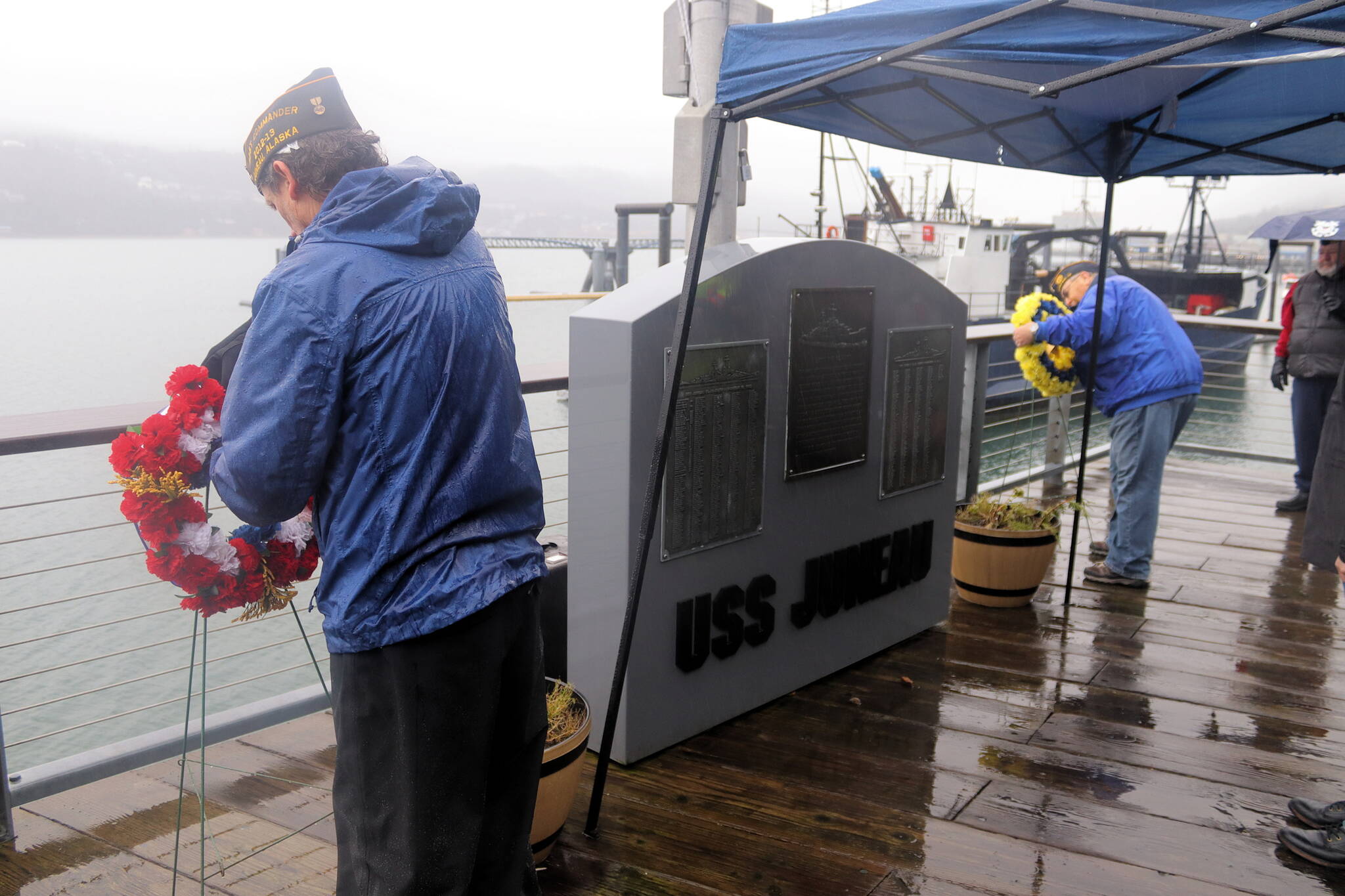 Rob Smith, left, of the American Legion Auke Bay Post 25, and Dan McCrummen, quartermaster of Veterans of Foreign Wars Taku Post 5559, place wreaths Sunday on either side of a memorial for the soldiers killed aboard the USS Juneau after it was sunk by torpedoes on Nov. 13, 1942. The current memorial site for the ship’s namesake town debuted 10 years ago after it was relocated from its original site near Marine Park. (Mark Sabbatini / Juneau Empire)