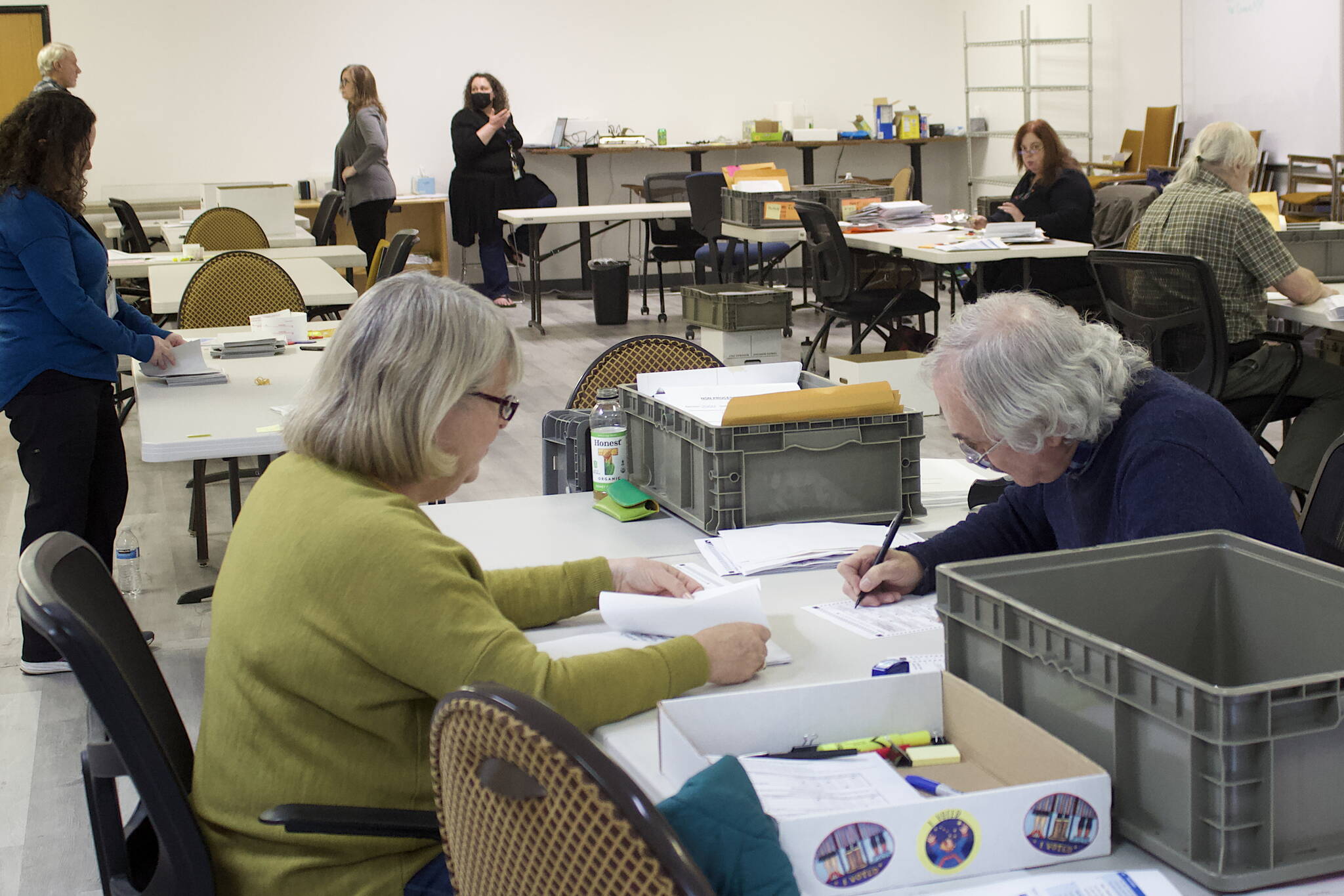 Mark Sabbatini / Juneau Empire 
Pat Tynan, left, and Tom Melville, review absentee ballots Tuesday at the Division of Elections office at the Mendenhall Mall. The review process is taking place in a separate room from where ballots are being tallied for the official results.