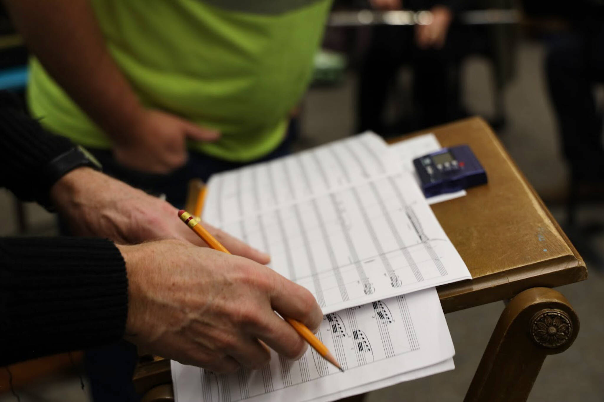 Mike Bucy writes on the score of local composer and musician Ben Holtz’s piece, Atmosphere with Radio Occultation, during the Con Brio Chamber Series’ Tuesday evening rehearsal. (Clarise Larson / Juneau Empire)