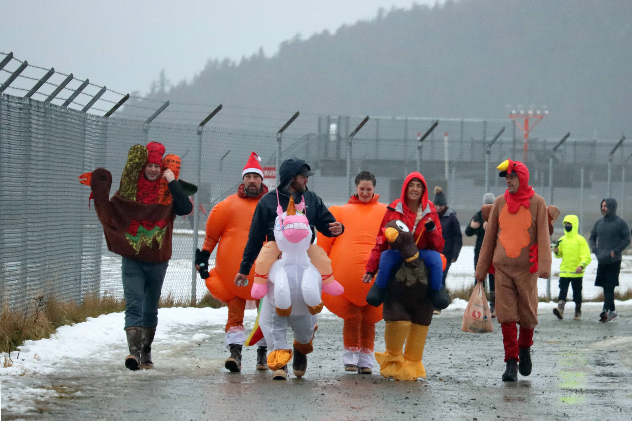 Matthew Wendel, Mike Kreis, Kasey Watts, Courtney Kreis, Tami Wahto and Todd Schur wore costumes during the 2021 Turkey Trot. Why’d they wear costumes? “Why not?” asked Schur. (Ben Hohenstatt / Juneau Empire File)
