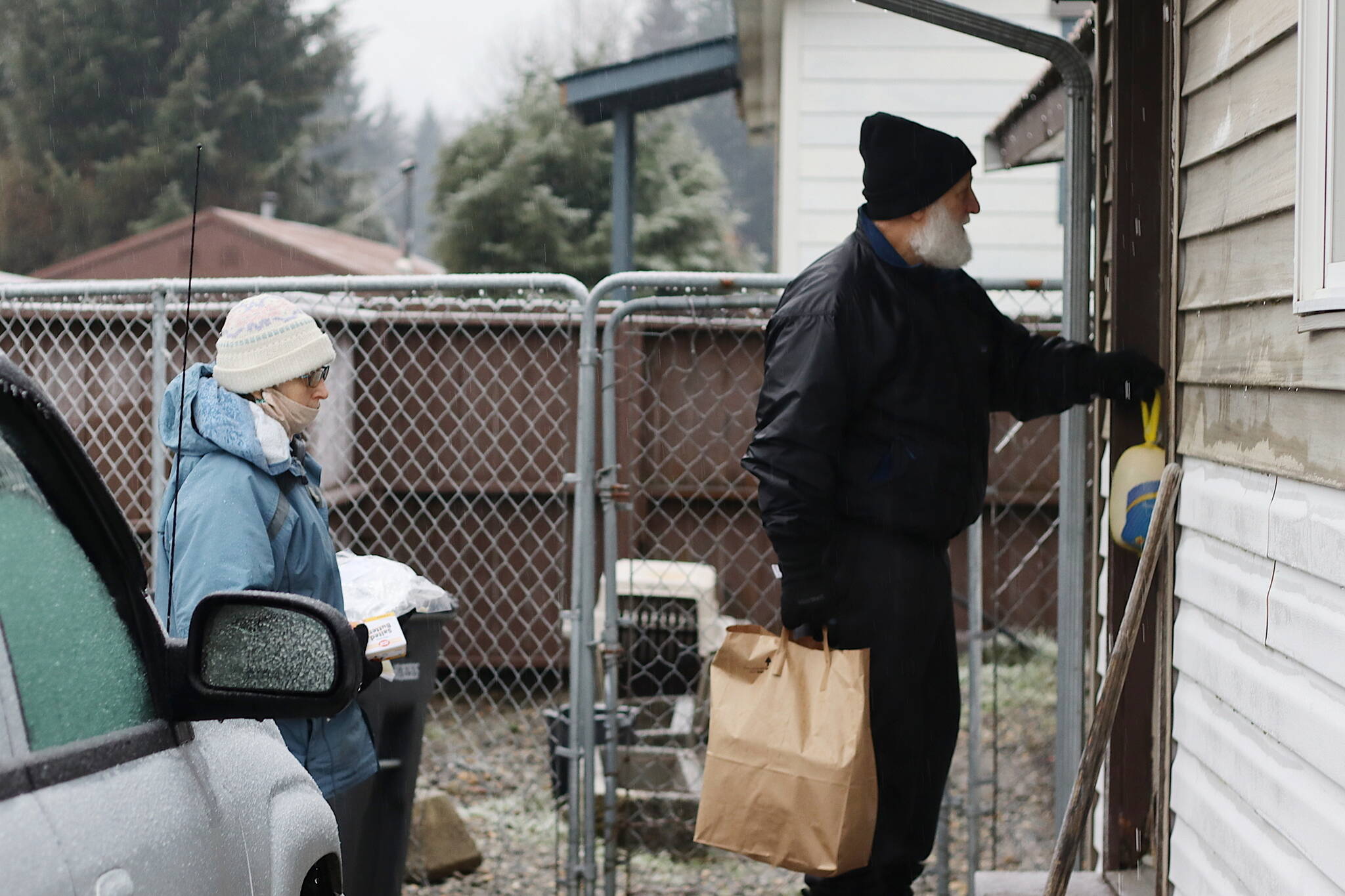 Mark Sabbatini / Juneau Empire 
Barbara Bechtold and John Tomaro deliver a Thanksgiving meal package to a Mendenhall Valley home on Saturday. The couple, both of whom have lived in Juneau since the 1970s, have made the deliveries and taken part in other volunteer efforts for many years. The estimated 300 to 400 packages being delivered this year are a collaborative effort by St. Vincent de Paul, The Salvation Army, The Glory Hall and other local entities.