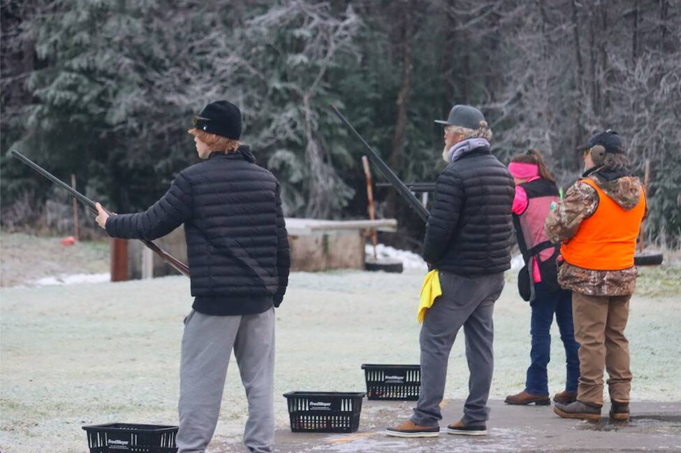 A member of the Juneau Gun Club helps participants with shooting clay targets, one of many events featured at the club’s annual Thanksgiving turkey shoot. (Jonson Kuhn / Juneau Empire)