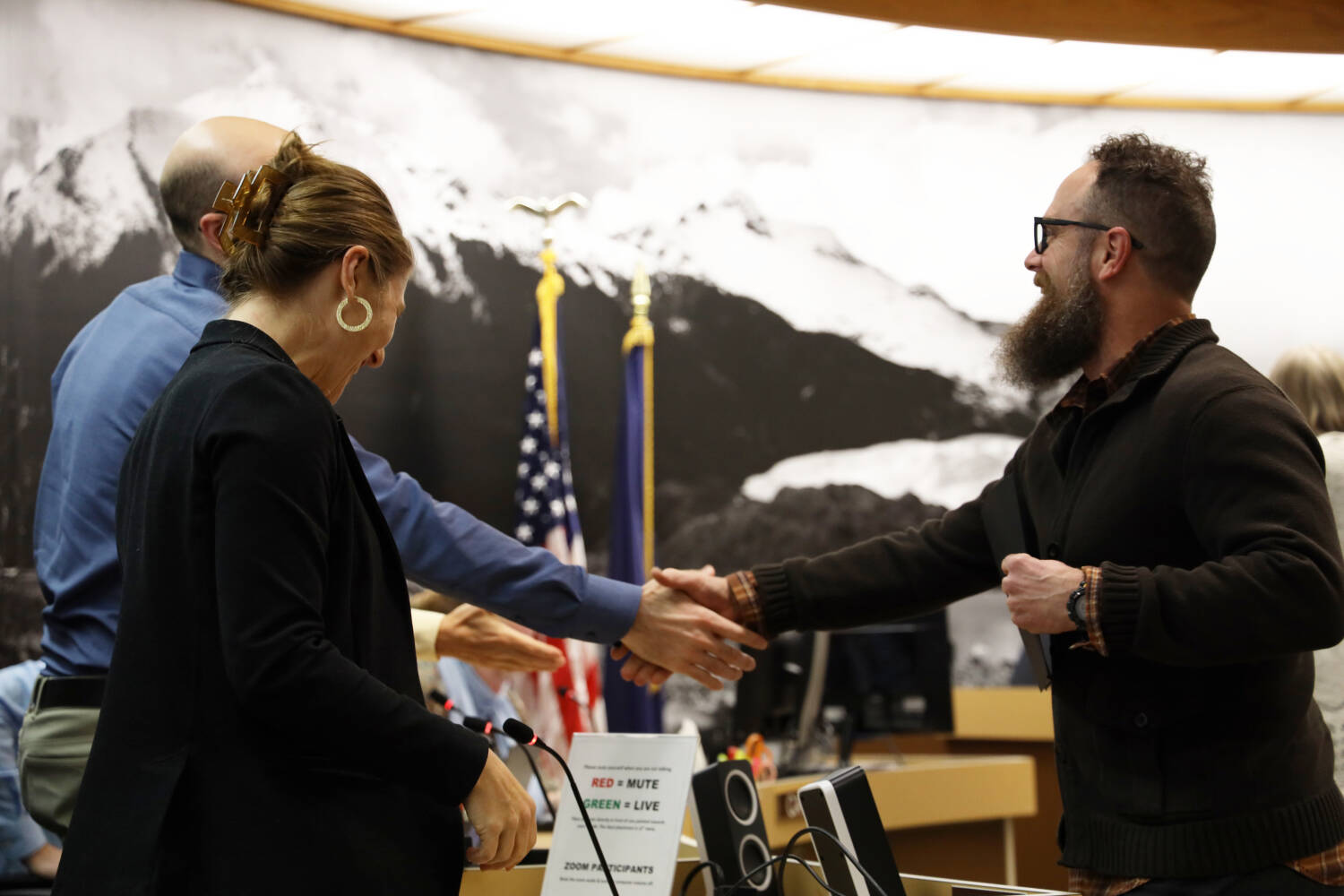 Mort Larsen shakes hands with City and Borough of Juneau Deputy City Manager Robert Barr at the Monday night Assembly meeting. Larsen, along with Mitchell McDonald were awarded a certificate of appreciation for their efforts and assistance during the Gastineau Avenue landslide. (Clarise Larson / Juneau Empire)