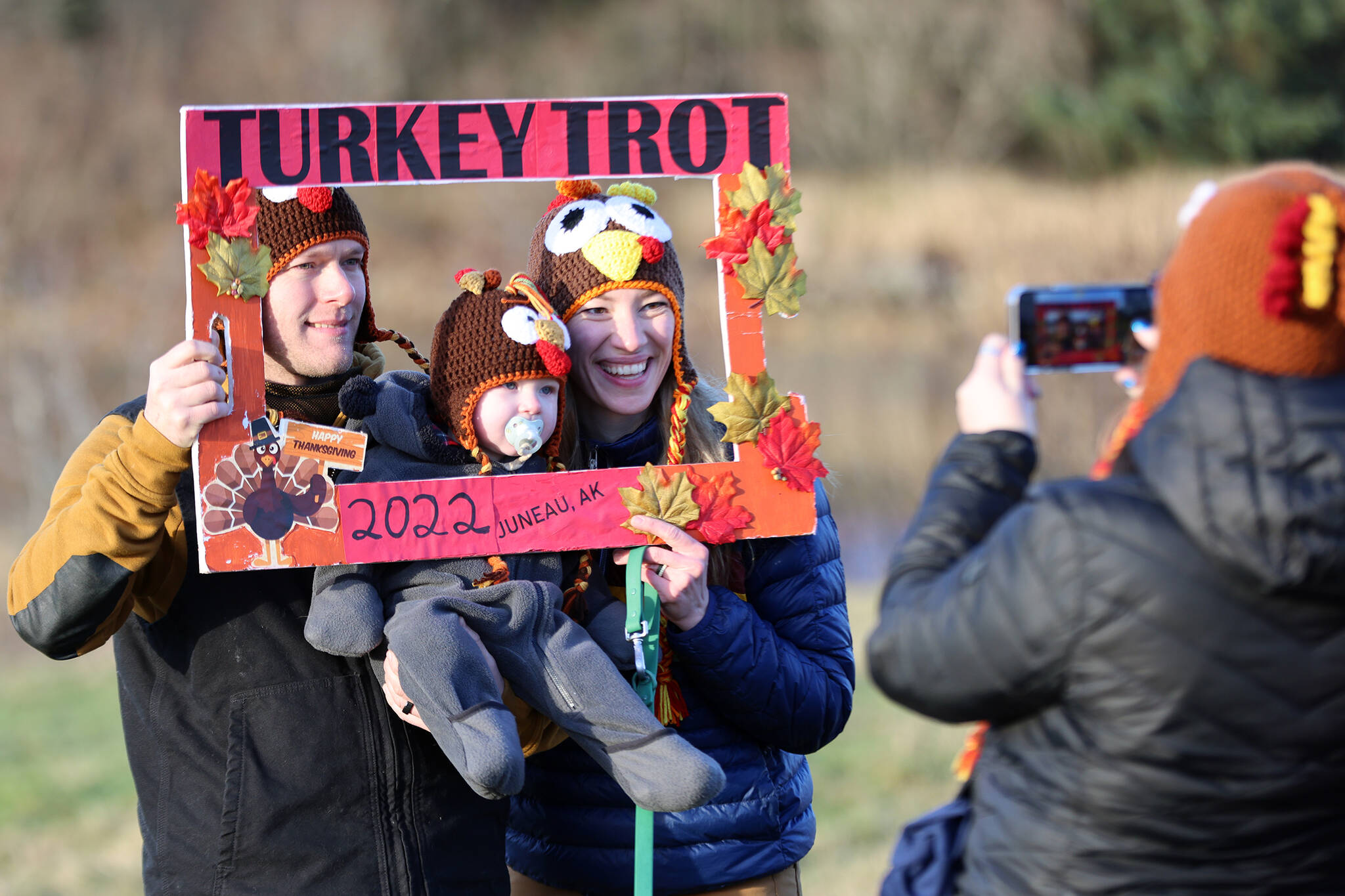 Josh, Bridger and Carolyn Smith pose for a photo taken by Misty Dohrn during the ninth annual Turkey Trot held Thursday. (Ben Hohenstatt / Juneau Empire)
