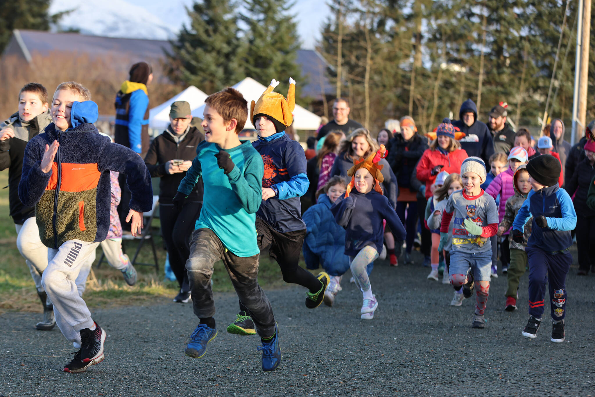 Mile runners takeoff from the starting line during the ninth annual Turkey Trot on Thursday. (Ben Hohenstatt / Juneau Empire)
