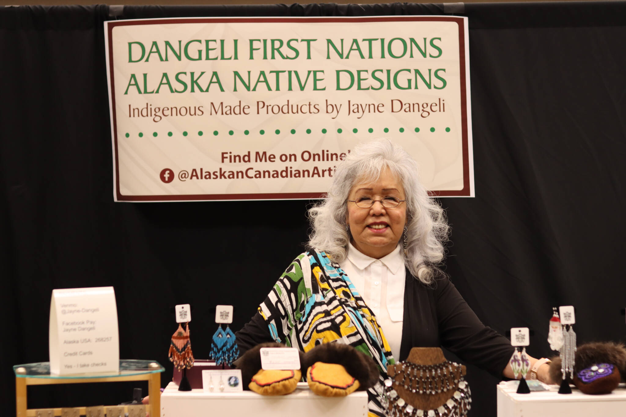 Local artists and 40-year Juneau resident Jayne Dangeli features her handmade Indigenous products through her store, Dangeli First Nations Alaska Native Designs at the Indigenous Artists & Vendors Holiday Market on Friday. (Jonson Kuhn / Juneau Empire)