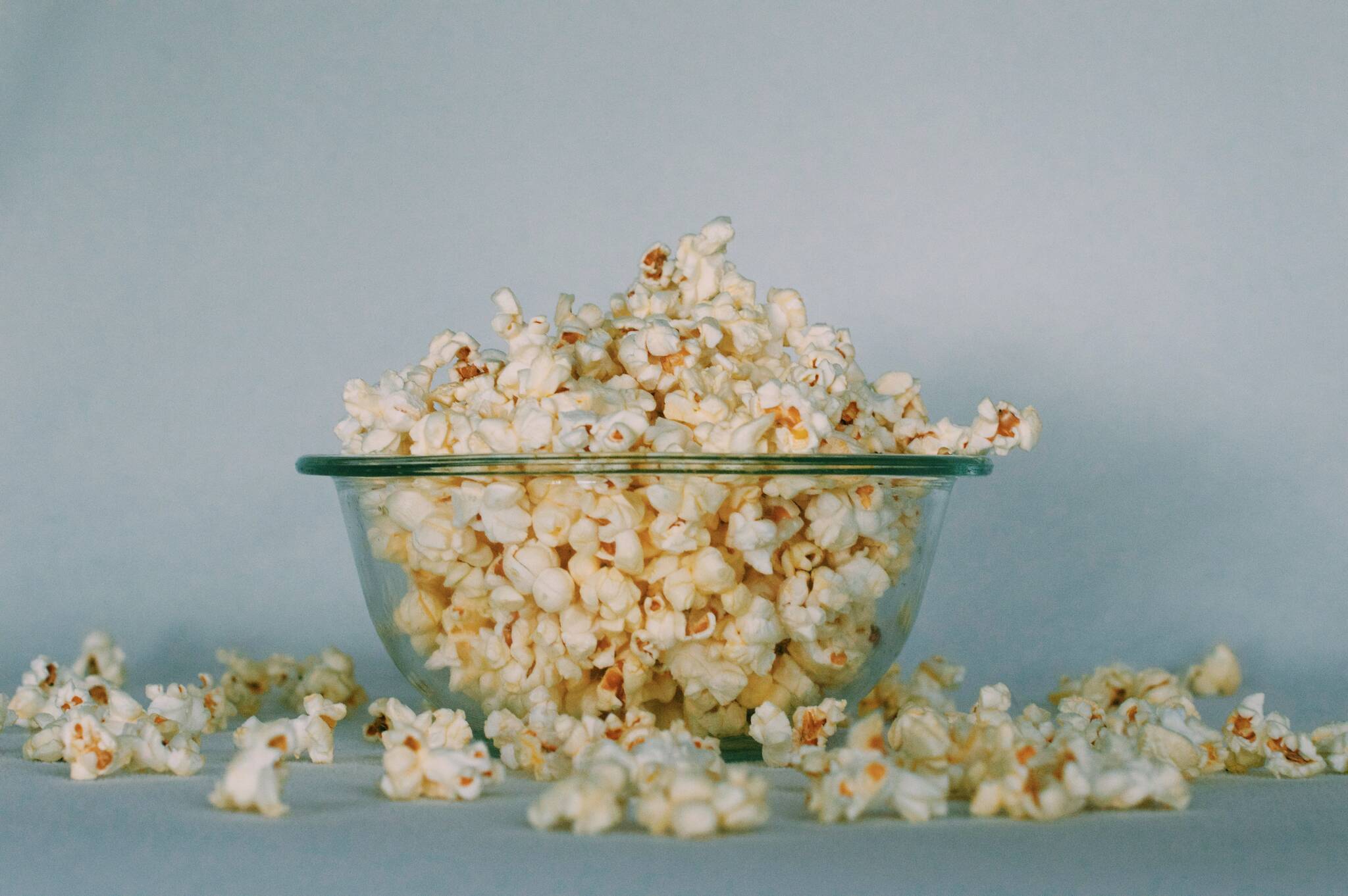 This photo shows a bowl of popcorn. "I love popcorn. When I play those ice-breaker games where you introduce yourself and name a favorite food, I always say, 'Peggy, popcorn.' writes Peggy McKee Barnhills. "It has a pleasing alliteration, making it easy for people to remember my name. Plus, it’s the truth. I love popcorn." (Georgia Vagim / Unsplash)