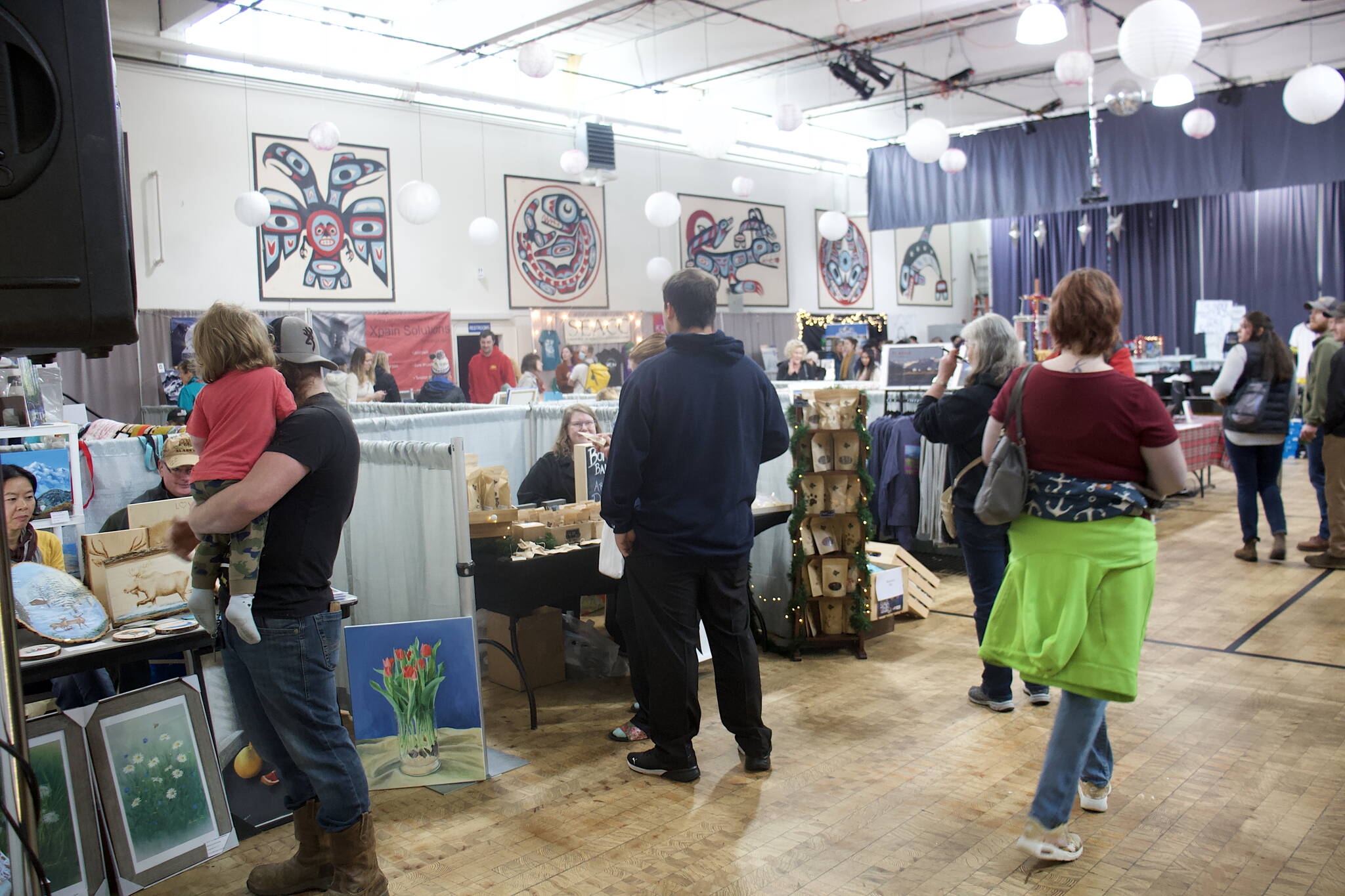Shoppers browse the tables at the Juneau Arts Humanities Council building on Saturday, one of three buildings where public market events are happening during the three-day Thanksgiving holiday weekend. (Mark Sabbatini / Juneau Empire)