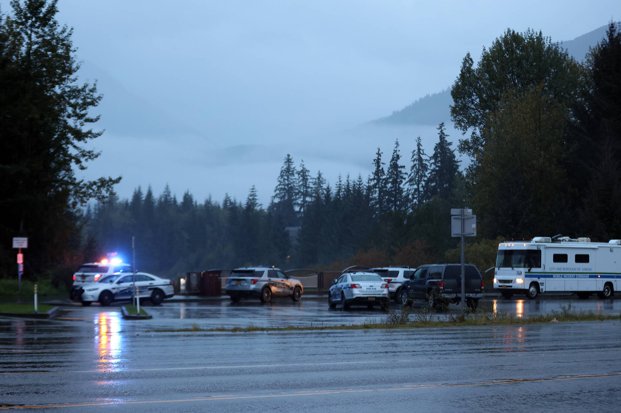 Police vehicles gather near Kaxdigoowu Héen Dei, also known as Brotherhood Bridge Trail on Sept. 21, 2022, the day police say Faith Rogers, 55, of Juneau was killed. (Ben Hohenstatt / Juneau Empire file)