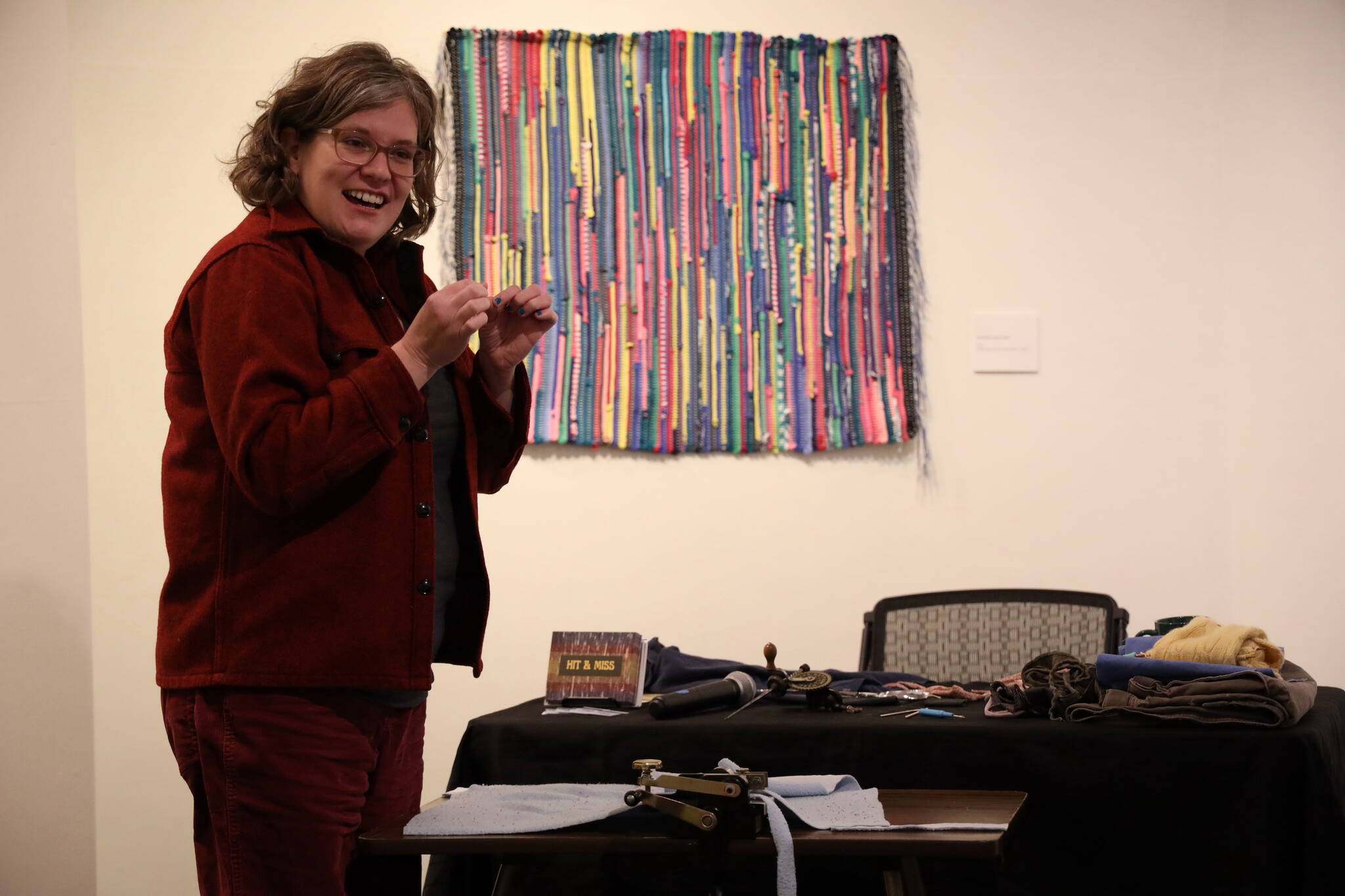 Multidisciplinary artist Mary McEwen talks about her experience learning to weave during her Artist Talk Saturday morning about her exhibition, “Hit & Miss: Adventures in Textile Reuse,” at the Juneau-Douglas City Museum. (Clarise Larson / Juneau Empire)