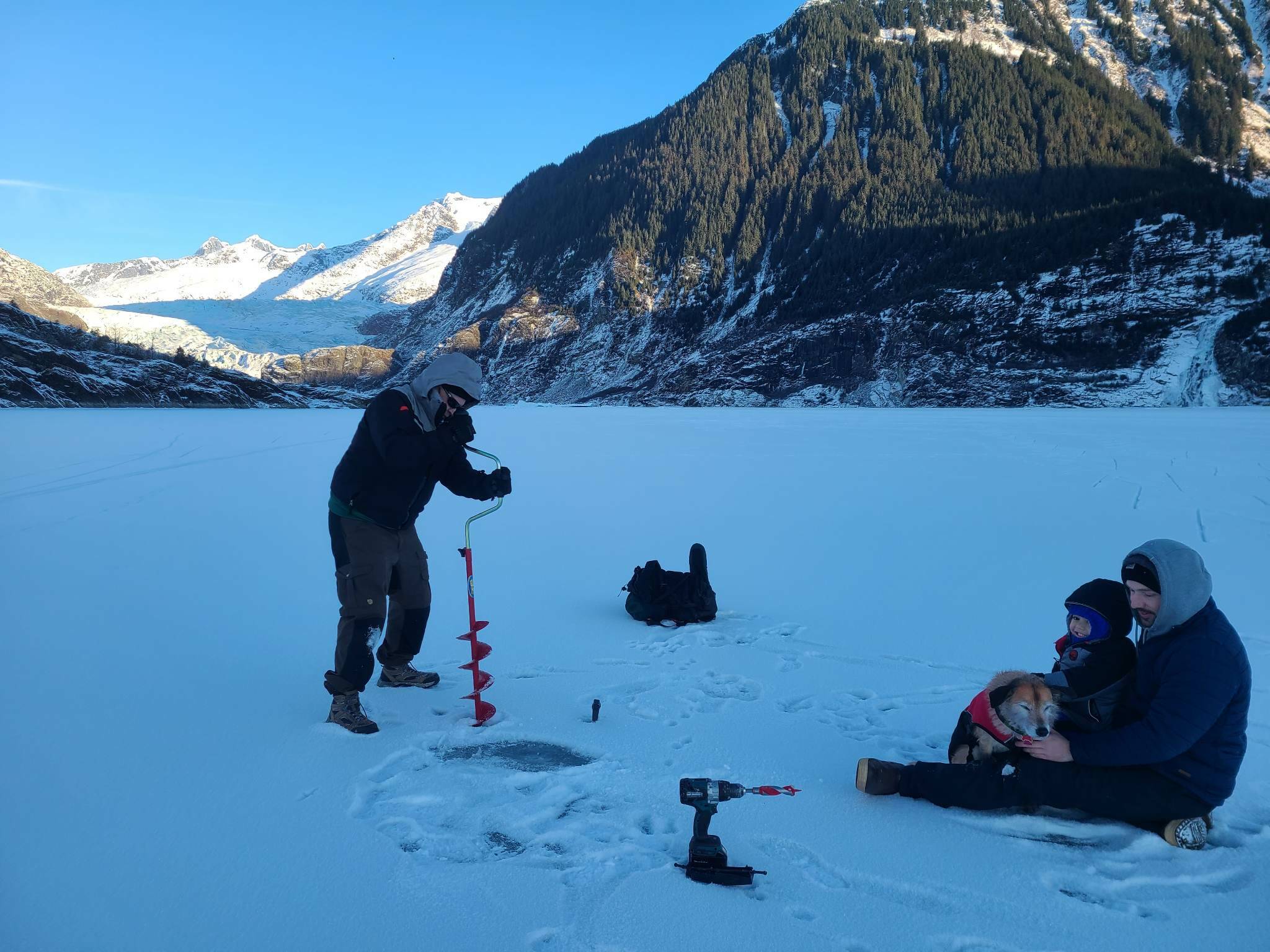 Brian Weed drills a hole on Mendenhall lake Monday morning. Weed said each winter he drills the lake around 3-4 times and has done so as a form of public service for around five years. This time around he said the average thickness was around six inches. (Courtesy / Brian Weed)