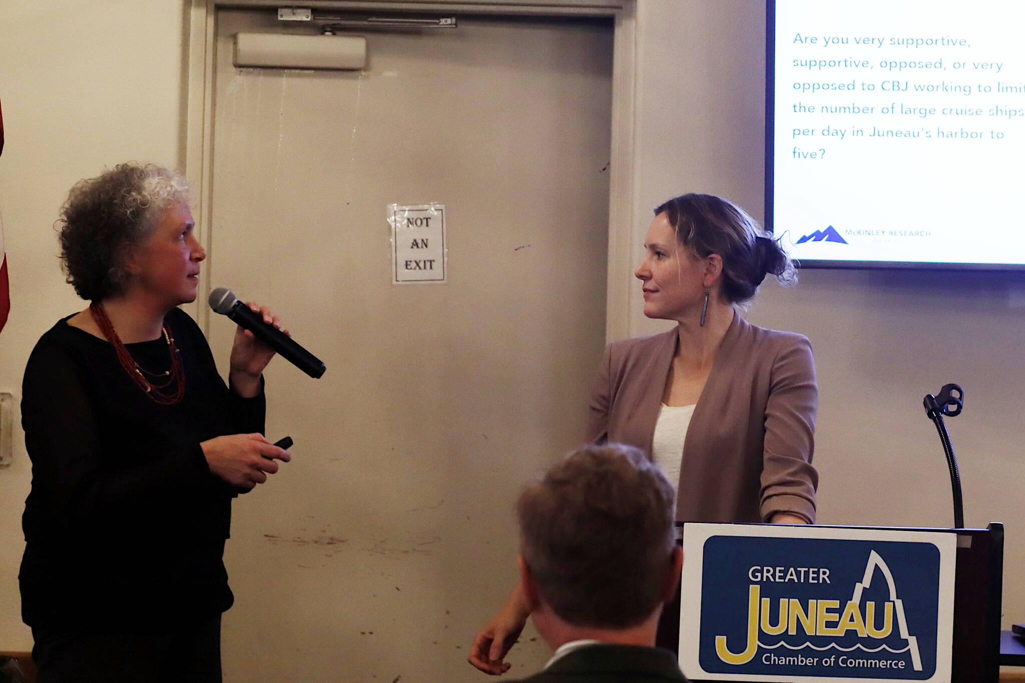 Mark Sabbatini / Juneau Empire 
McKinley Research Group President Susan Bell, left, and CBJ Tourism Manager Alexandra Pierce discuss the results of an annual survey of residents about tourism during the Juneau Chamber of Commerce’s weekly luncheon Thursday at the Juneau Moose Family Center.