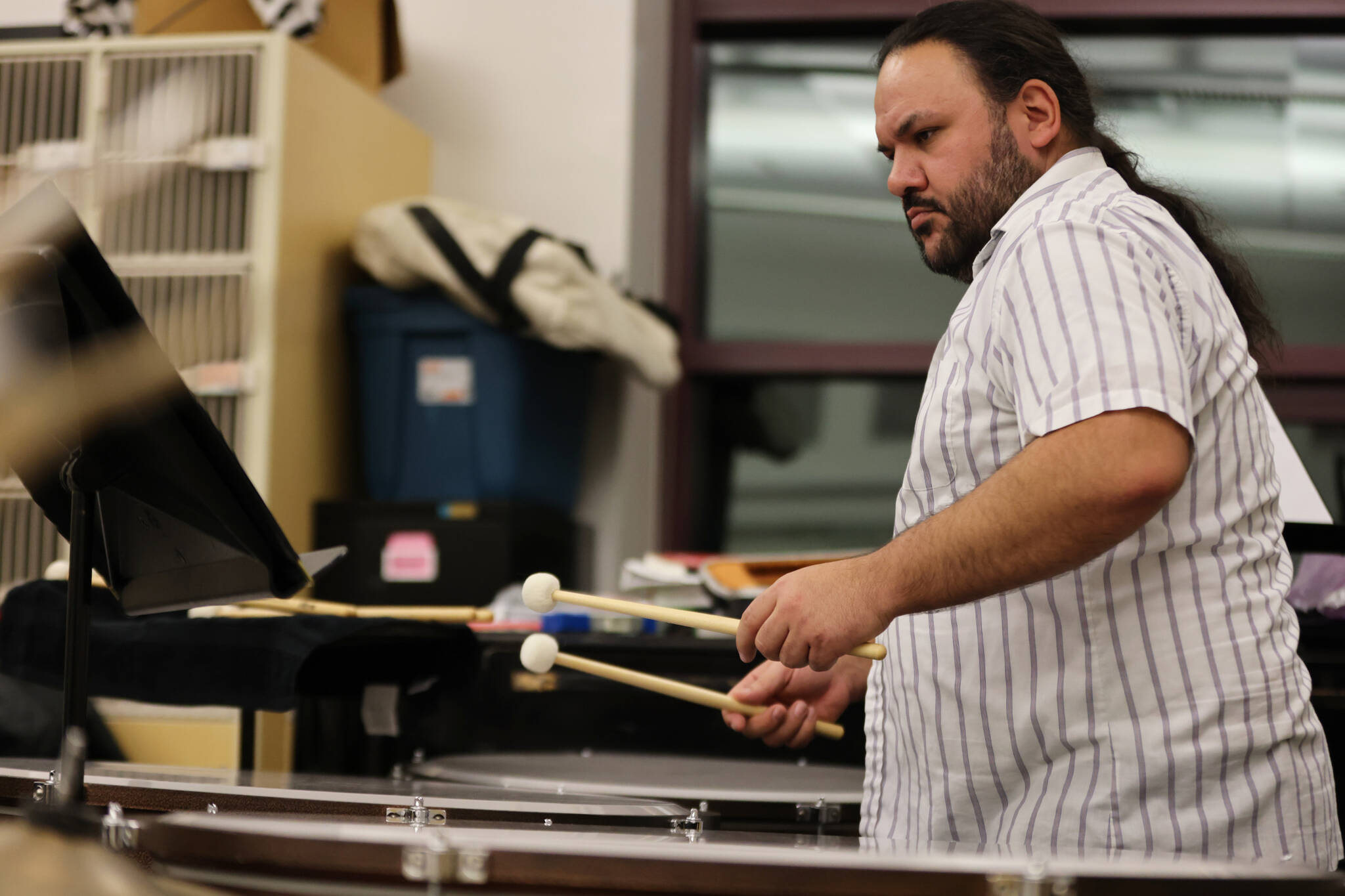 Percussionist Ed Littlefield prepares to strike a timpani during rehearsals for Juneau Symphony’s upcoming Holiday Cheer concert. (Ben Hohenstatt / Juneau Empire)