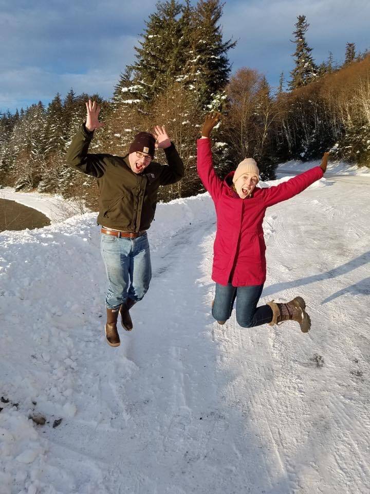 Theresa Hicks and friend Patrick Chamberlin have a celebratory jump after harvesting a tree from the Tongass National Forest. (Courtesy Photo / Theresa Hicks)
