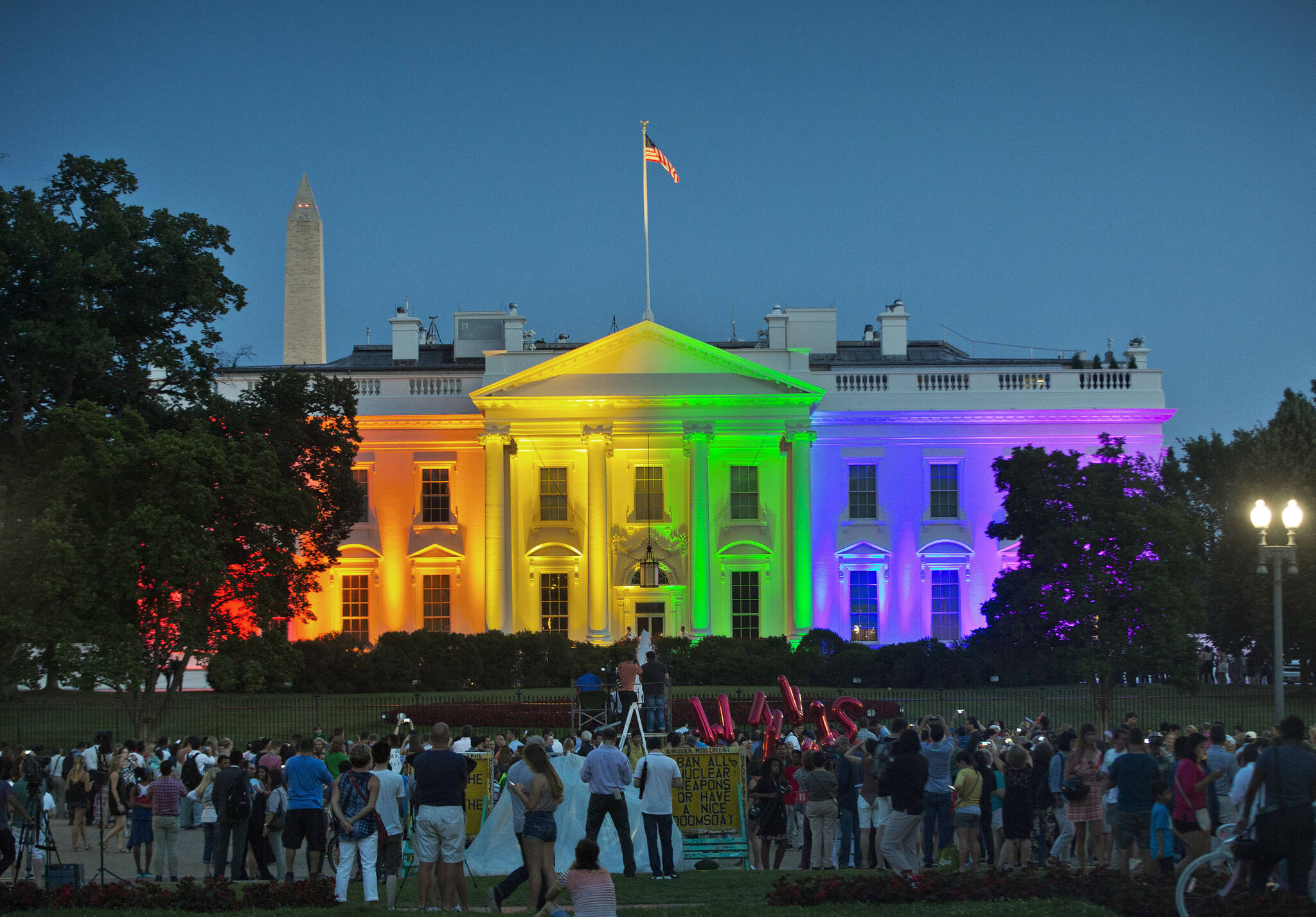 People gather in Washington’s Lafayette Park to see the White House illuminated with rainbow colors to mark the U.S. Supreme Court’s ruling to legalize same-sex marriage, June 26, 2015. President Joe Biden plans to sign legislation this coming week that will protect gay unions even if the Supreme Court revisits its ruling supporting a nationwide right of same-sex couples to marry. It’s the latest part of Biden’s legacy on gay rights, which includes his unexpected endorsement of marriage equality on national television a decade ago when he was vice president. (AP Photo / Pablo Martinez Monsivais)