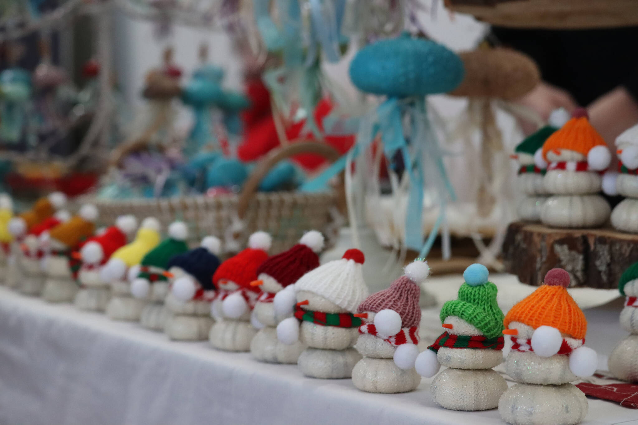 Margaret Mimnaugh with Tidal Creations from Ketchikan sets up her seasonal creations made with found hand painted sea urchin shells, along with snowmen and jelly fish at this year’s Stocking Stuffer Showcase on Saturday the Juneau Arts and Culture Center. (Jonson Kuhn / Juneau Empire)