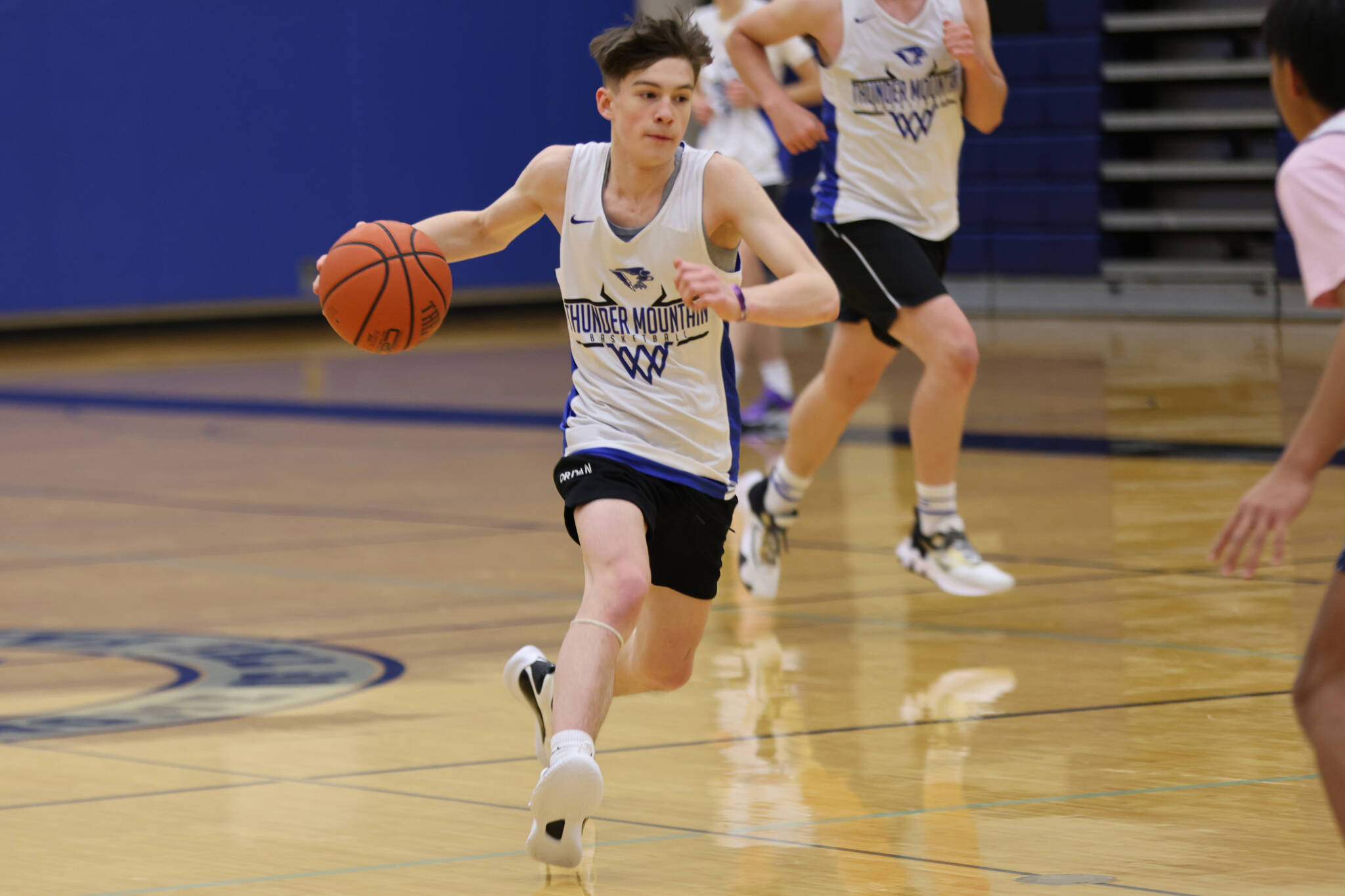 Samuel Lockhart  dribbles down the court while looking for a teammate cutting toward the hoop during a drill at Thunder Mountain High School. The 2022-23 iteration of the  TMHS boys basketball returns last year's leading scorers.