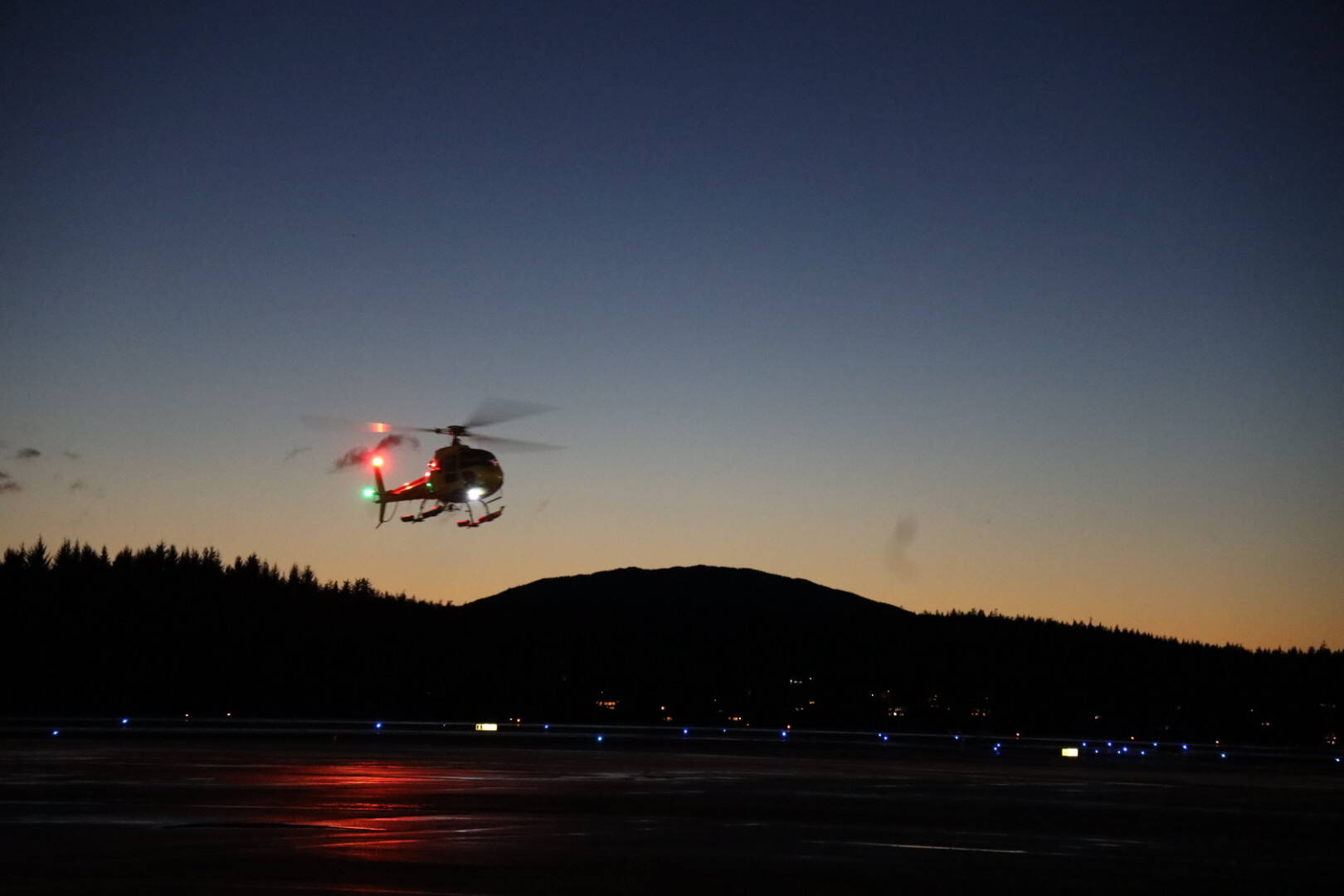 A helicopter with Santa Claus on board makes its way toward Juneau International Airport. (Clarise Larson / Juneau Empire)