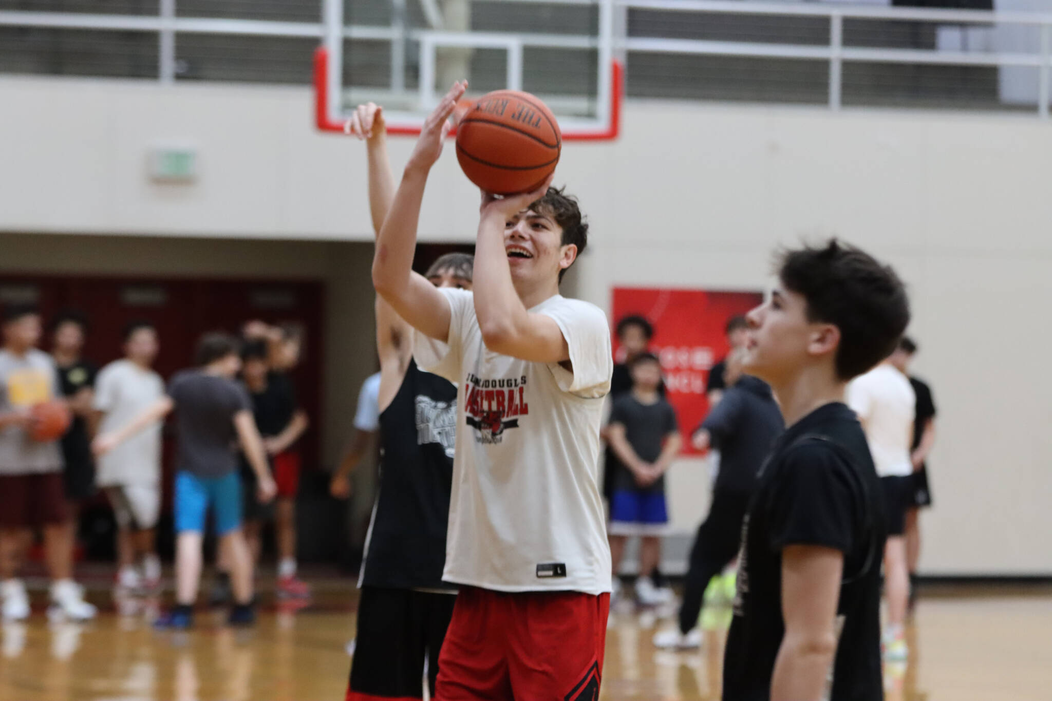 From Left to right, JDHS players seniors Joey Aline, Orion Dybdahl and freshman Brandon Casperson work on free throws during a Wednesday night practice. (Jonson Kuhn / Juneau Empire)