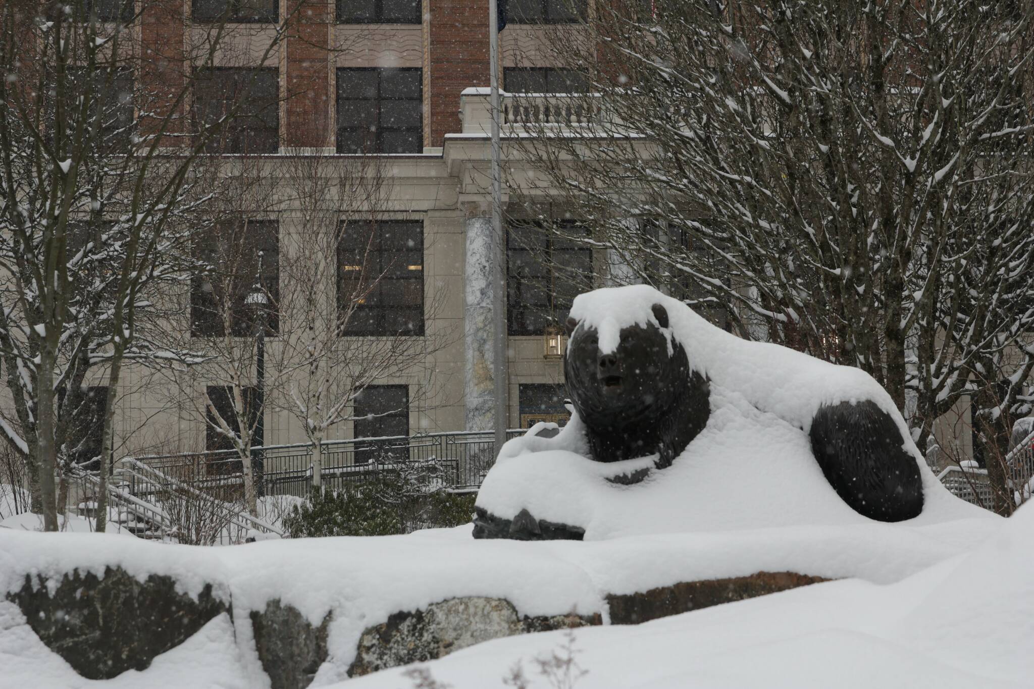 Snow blankets a statue in front of the Alaska State Capitol. (Michael S. Lockett / Juneau Empire File)
