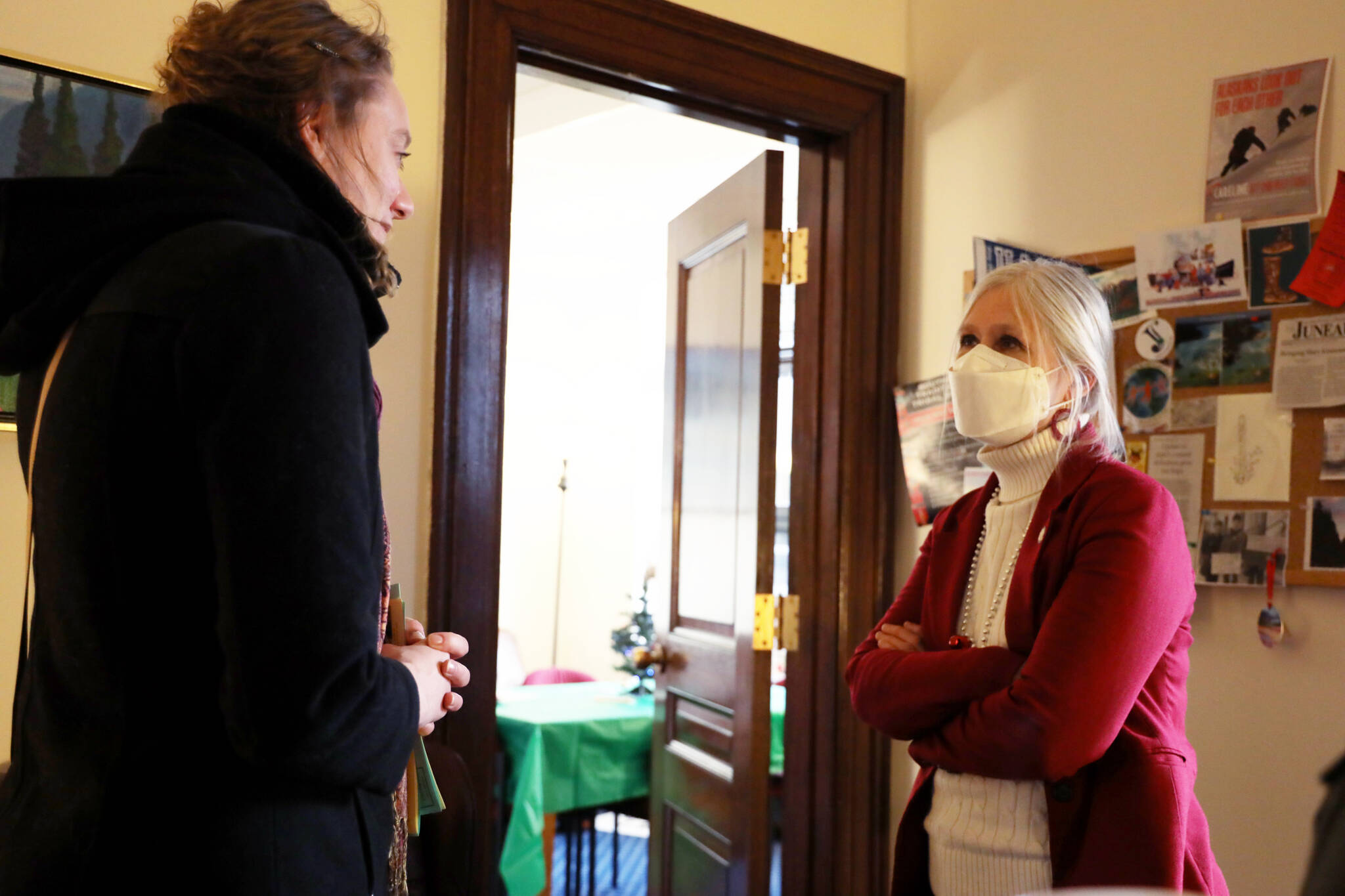State Rep. Andi Story chats with Tawnya Kreft at her office in the Alaska State Capitol during the Juneau legislative delegations holiday open house Thursday afternoon. (Clarise Larson / Juneau Empire)