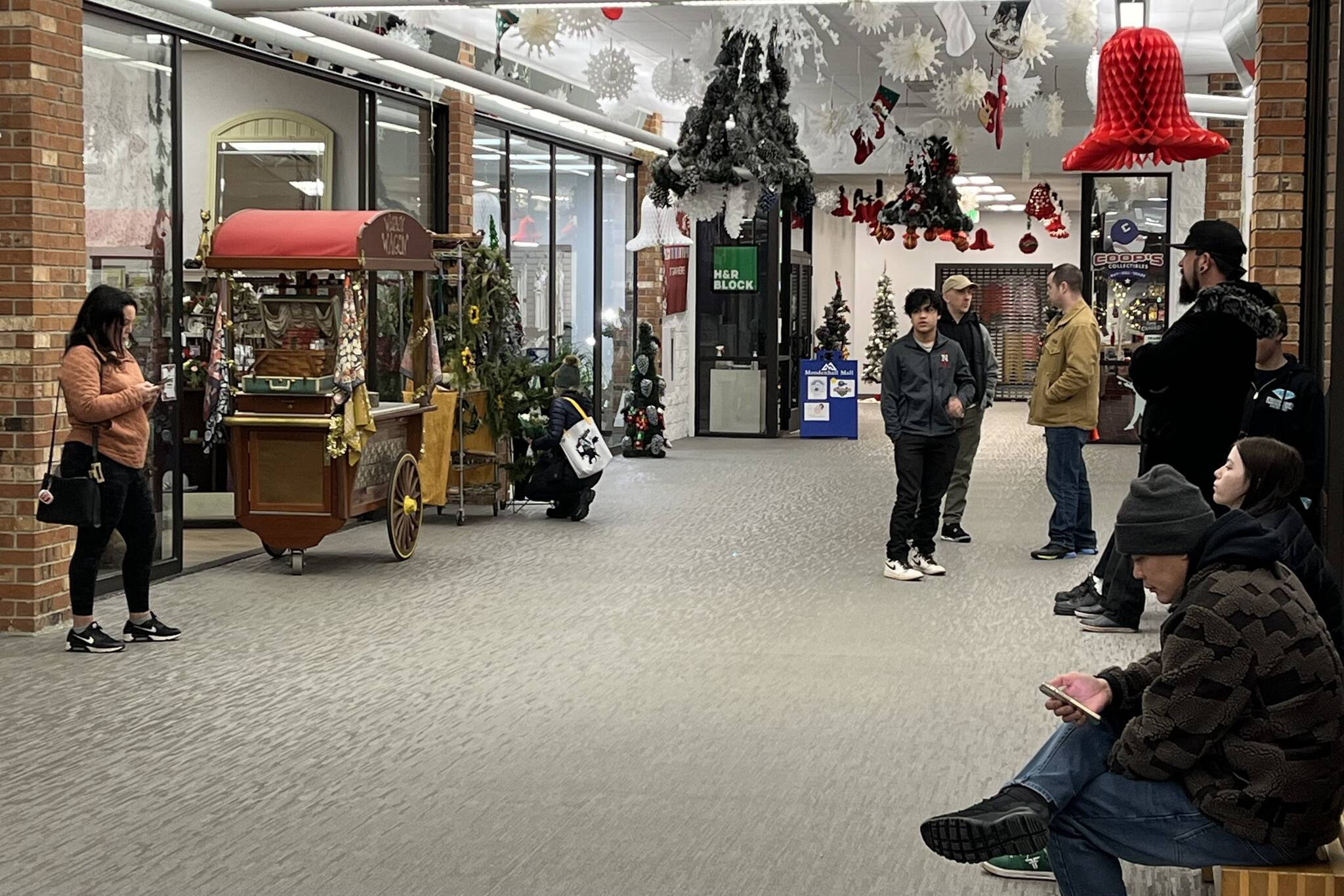 A line of people wait patiently for shops to officially open to get in some last minute shopping for the holidays at the Mendenhall Mall on Thursday. (Jonson Kuhn / Juneau Empire)