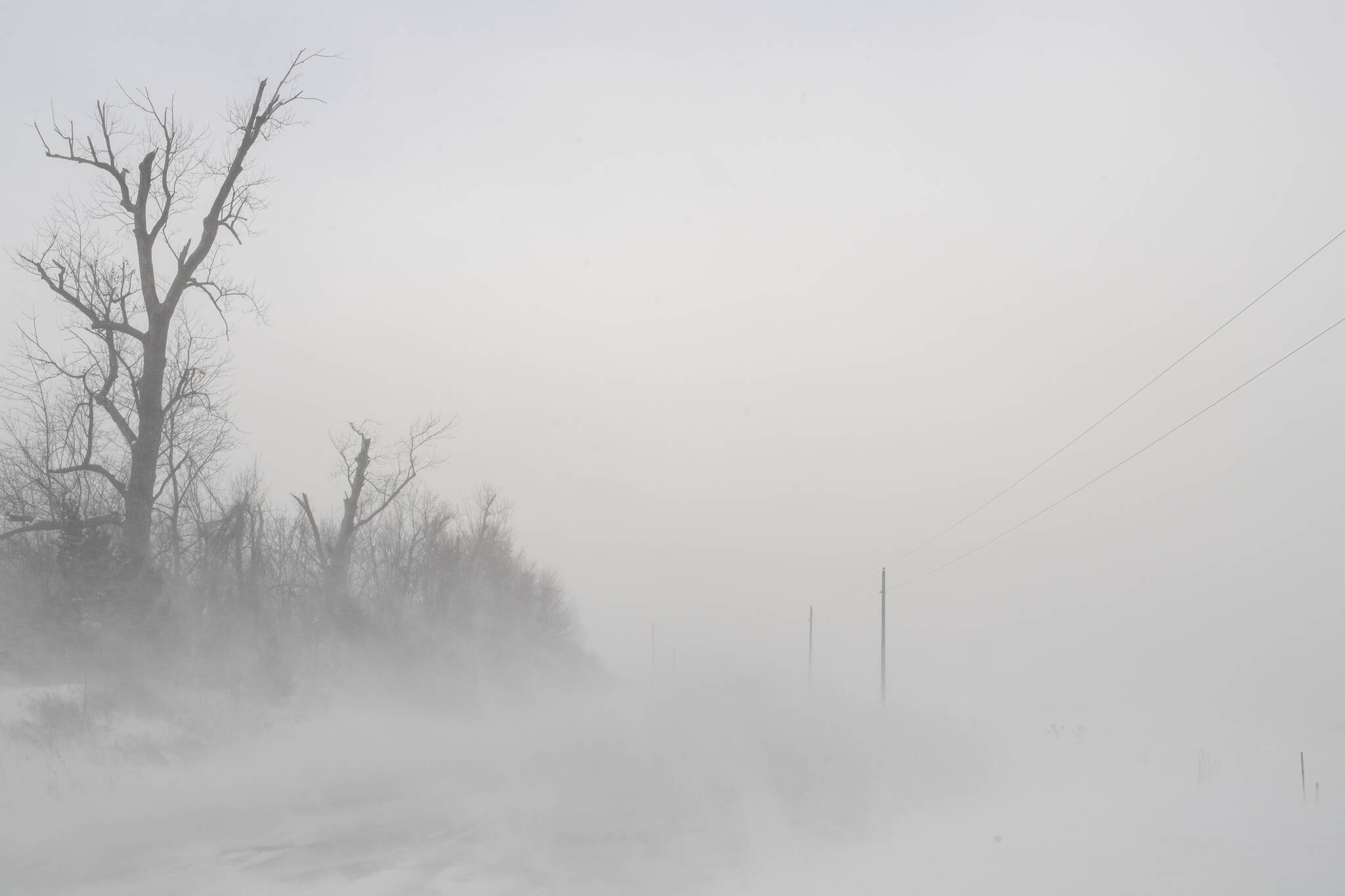 Blowing snow impairs visibility in rural Linn County, Iowa, on Friday, Dec. 23, 2022. A winter storm brought wind chill values of more than 30 degrees below zero and whiteout conditions to Eastern Iowa. (Nick Rohlman / The Gazette)