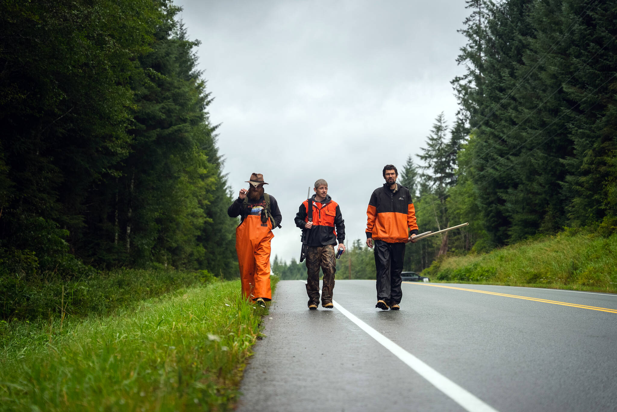 In fall 2021, Quinn Aboudara (left) and crew members Wade Hulstein (center) and Jon Carle walk along a road to access a stream for monitoring work near Klawock Lake. Today, Quinn Aboudara is the Natural Resource Stewardship Coordinator for Shaan Seet Inc., Wade Hulstein is the Klawock Community Catalyst for the SSP at the Klawock Cooperative Association, and Jon Carle is the Indigenous Stewards Coordinator with the Prince of Wales Tribal Conservation District.
