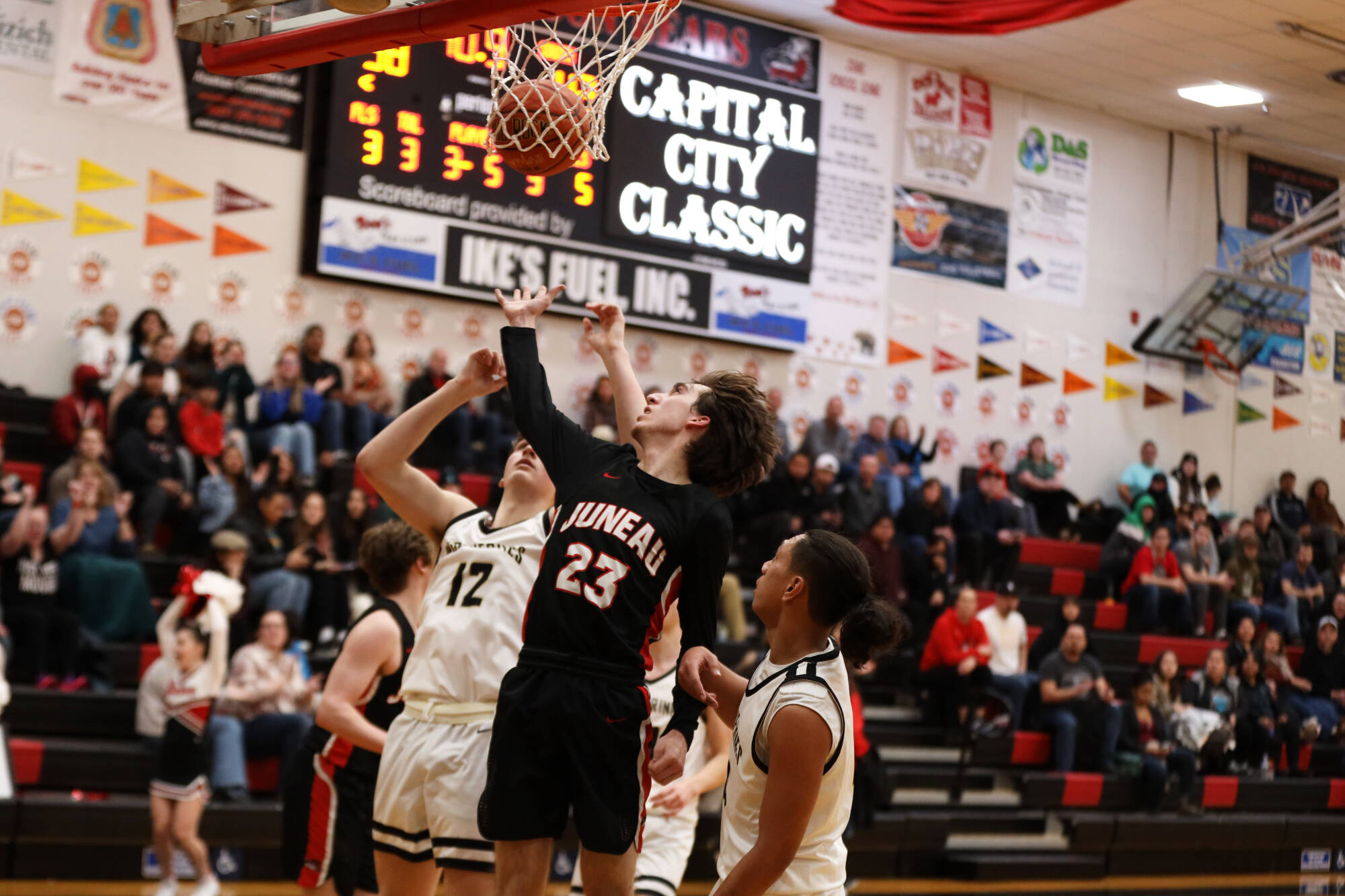 Senior guard Joseph Aline jumps for the ball during the third period during Thursday night’s game against South Anchorage High School during the first night of the Princess Cruises Capital City Classic. (Clarise Larson / Juneau Empire)