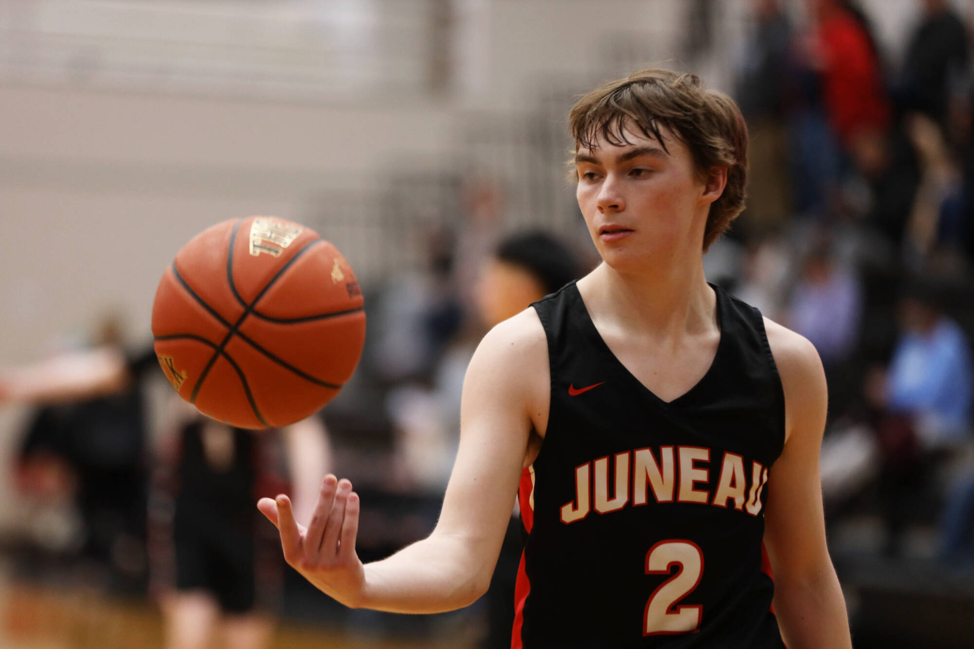 Senior Bodhi Nelson throws the ball up during warm ups going into the second half during Thursday night’s game against South Anchorage High School during the first night of the Princess Cruises Capital City Classic. (Clarise Larson / Juneau Empire)