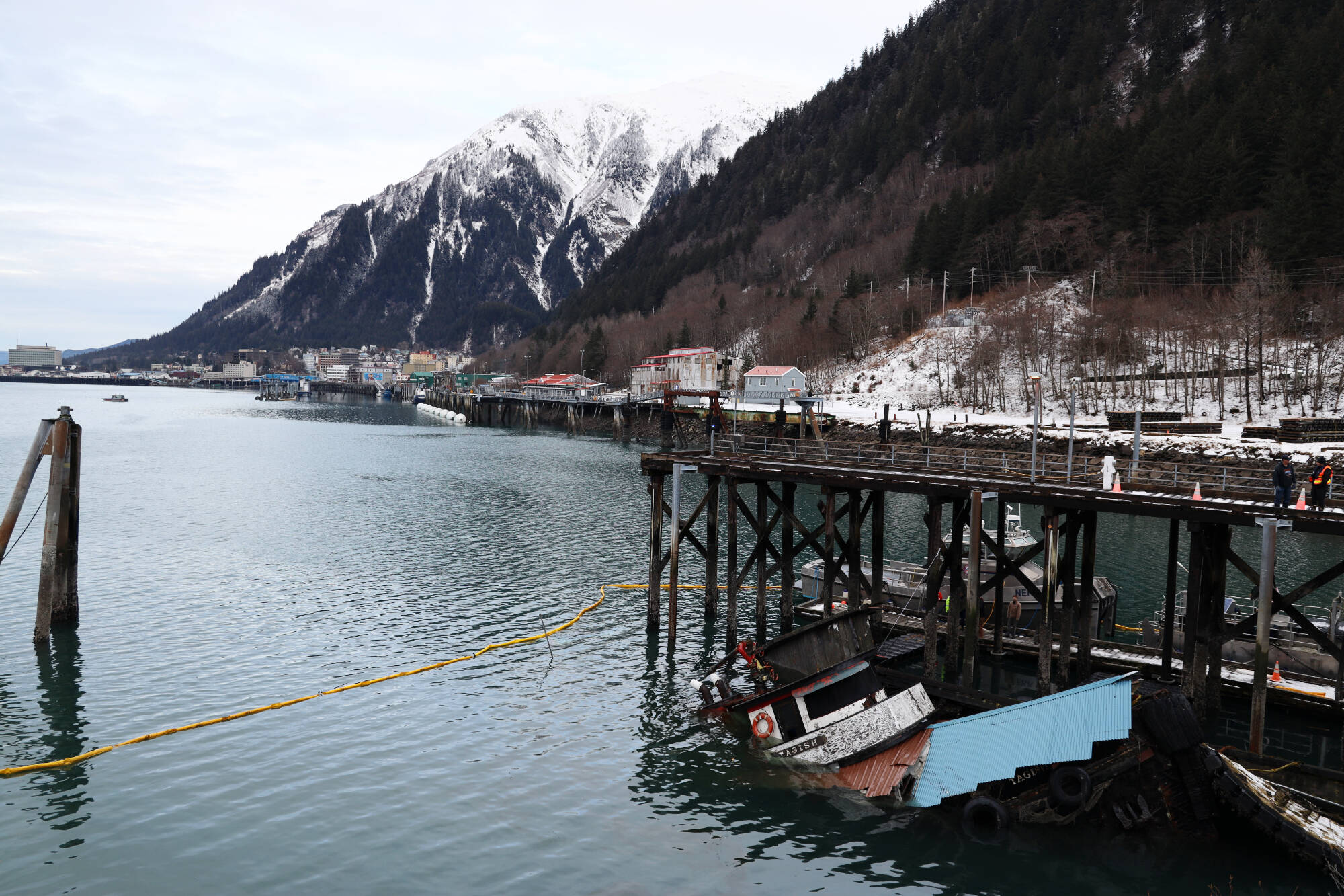 The privately owned 107-foot tugboat named Tagish sits partially below the water next to the National Guard dock south of the downtown cruise ship docks Thursday morning. Recovery plans by the owner are now underway, but are expected to come at a steep price. (Clarise Larson / Juneau Empire)