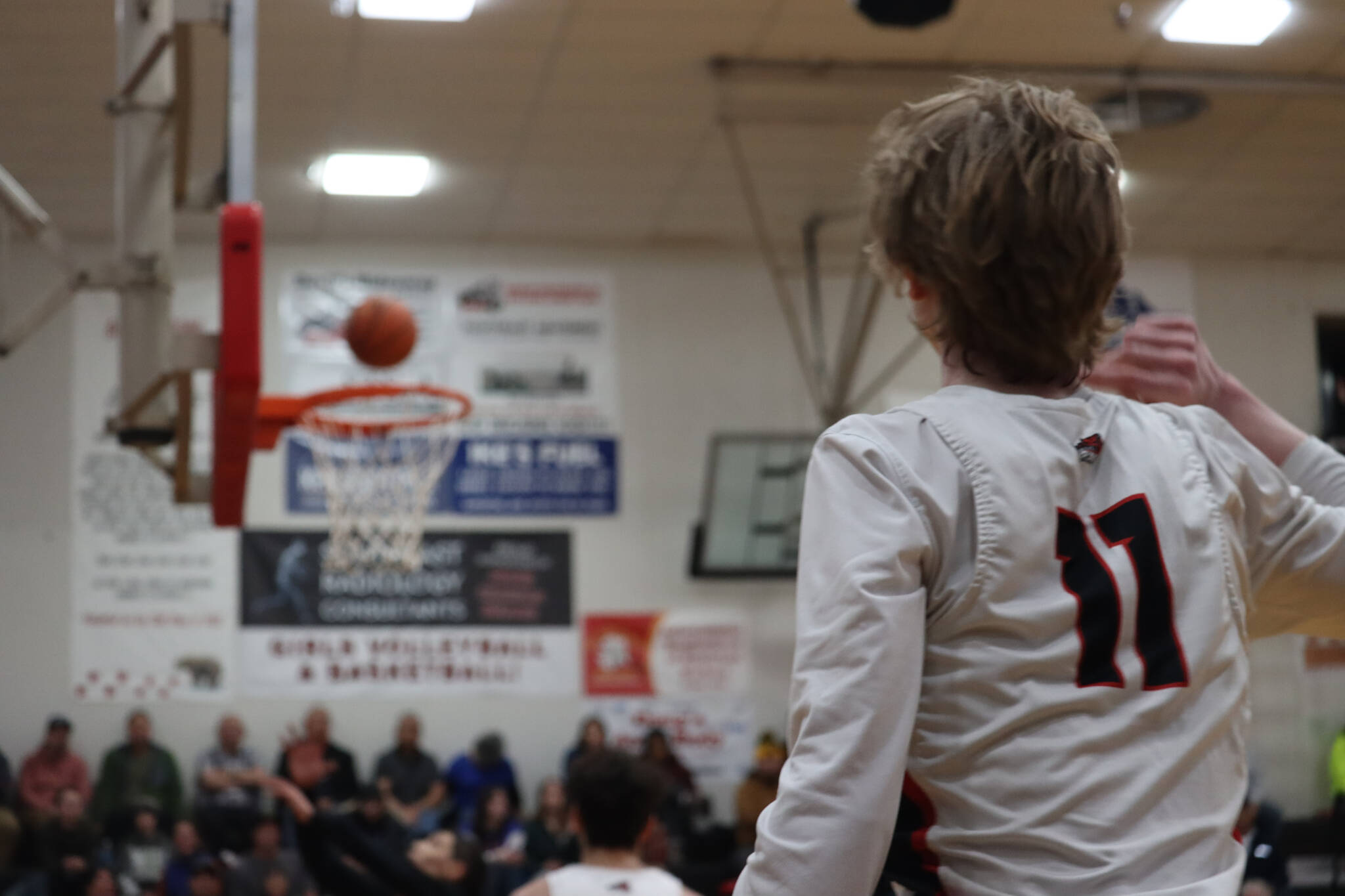 JDHS junior guard Sean Oliver watches as he sinks a 3-point shot during Friday’s game against West Valley High School for the closing game of the Capital City Classic tournament. Oliver led the Crimson Bears Boys team with a total of 12 points. (Jonson Kuhn / Juneau Empire)
