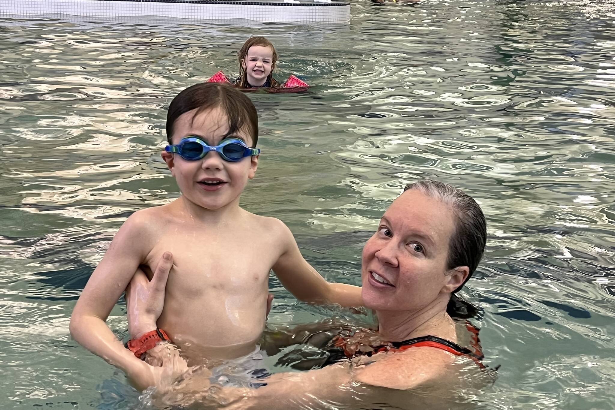 Barrow and Lupin West cheer on their mom Olivia Barrow while she swims laps at Family Day at the Park on Saturday. (Jonson Kuhn / Juneau Empire)