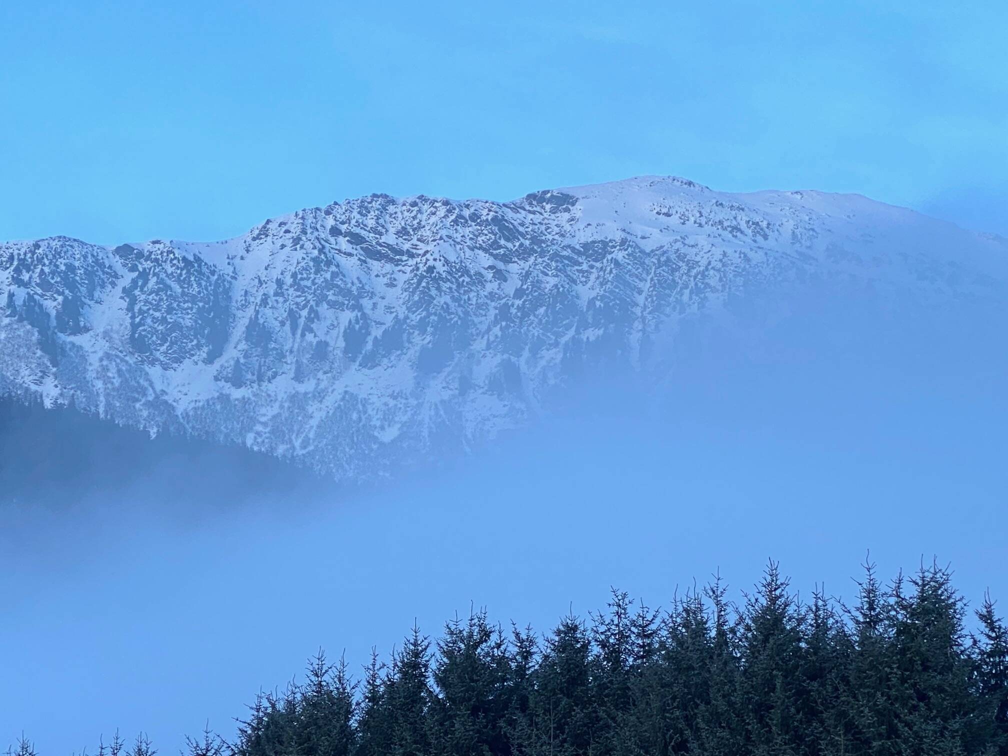 Fog creeps up and over Heinzelmann Ridge. (Courtesy Photo / Denise Carroll)