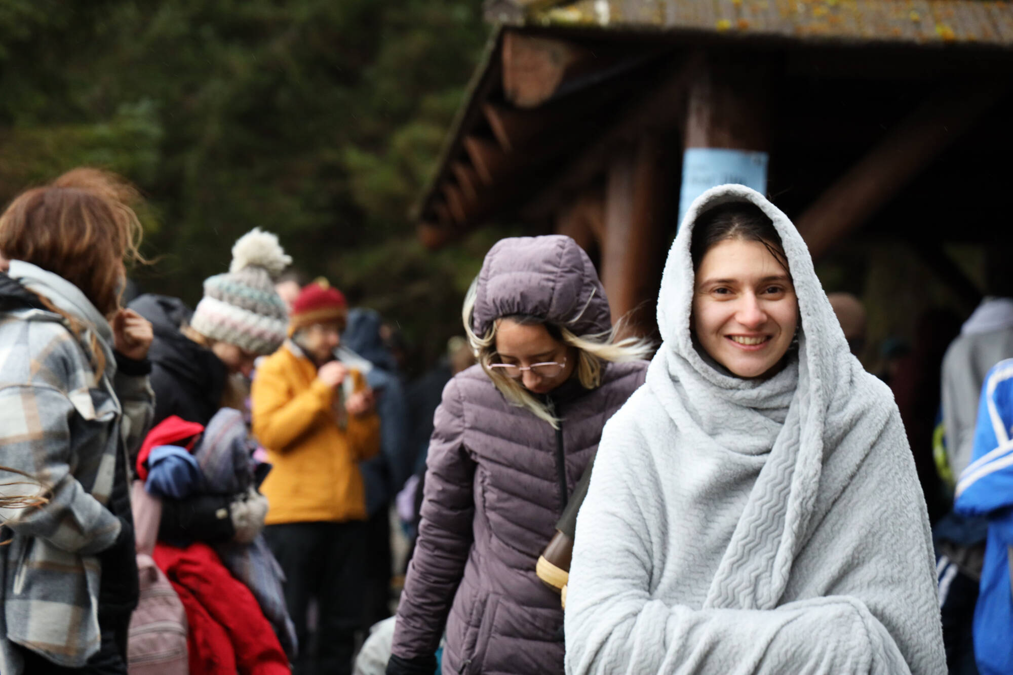 Lourdes Marteleur smiles while wrapped in a blanket after participating in the annual Polar Dip at the Auke Recreation Area Sunday afternoon. (Clarise Larson / Juneau Empire)