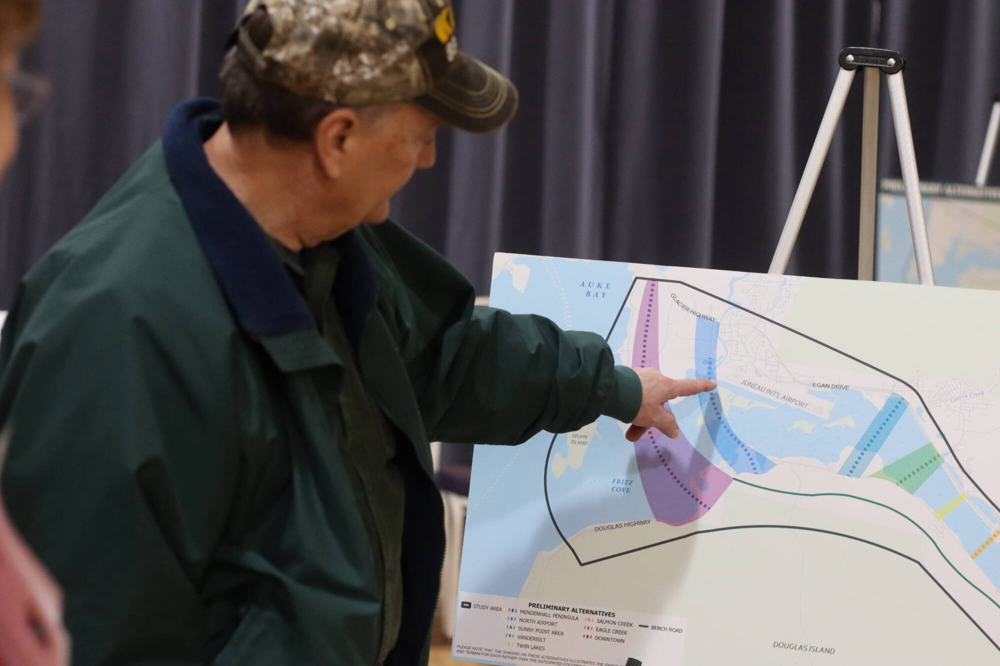 Juneau resident Denny DeWitt looks at the options for a second Douglas crossing during an open house as part of the evaluation process in early December at the Juneau Arts Humanities Council building. (Mark Sabbatini / Juneau Empire)