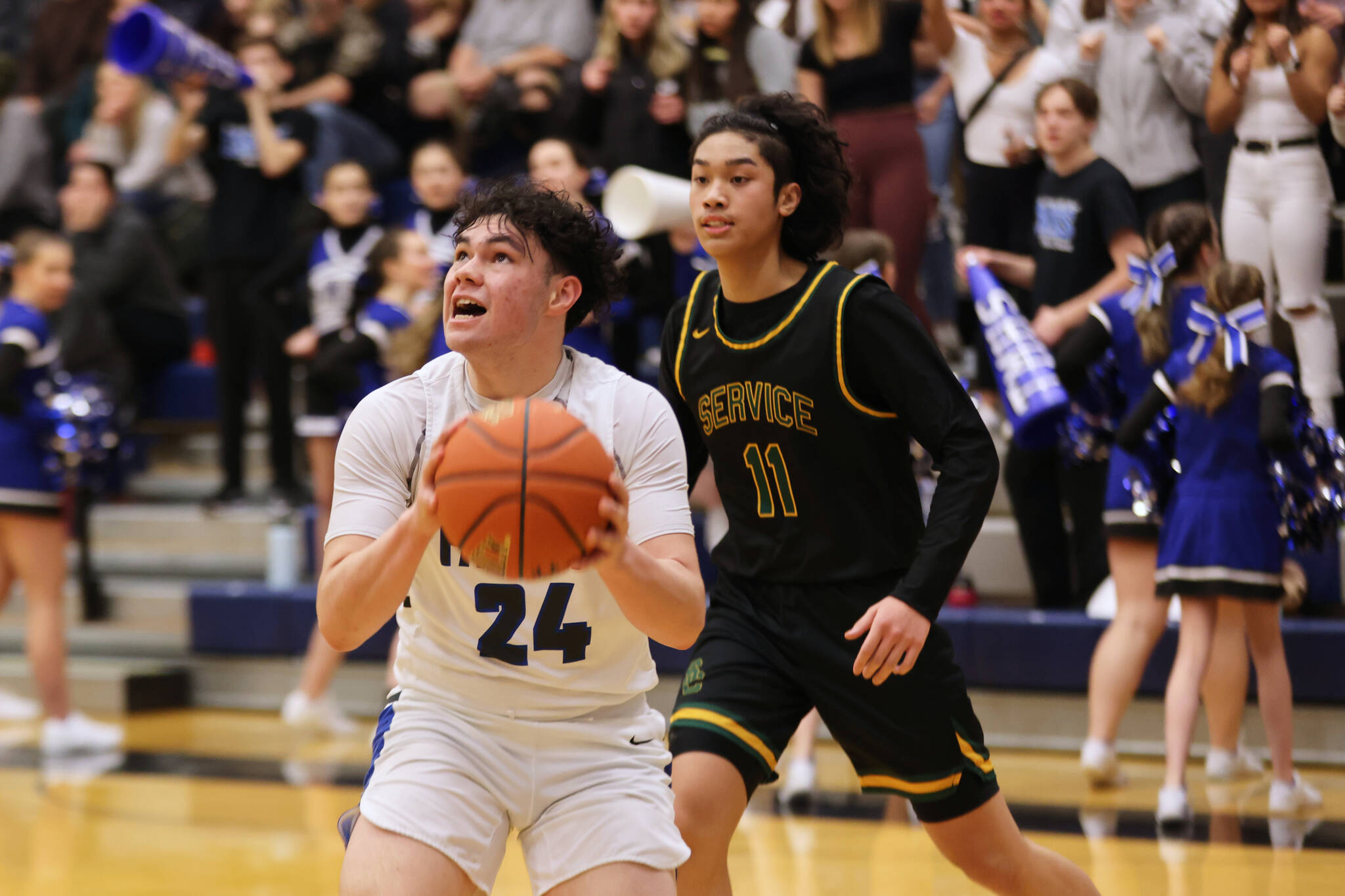 TMHS senior MJ Tupou prepares for a contested shot at the hoop during a game against Service High School. (Ben Hohenstatt / Juneau Empire)