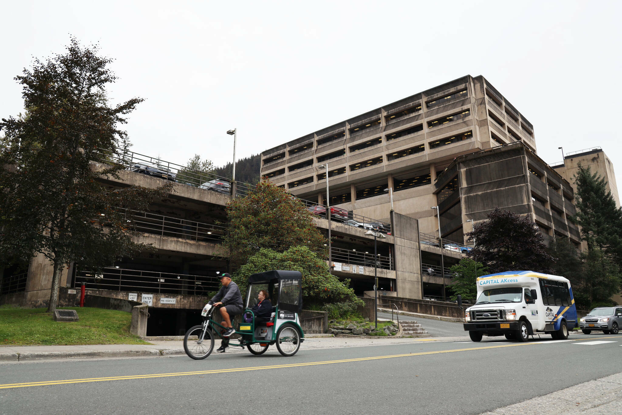 A cycle rickshaw passes the North State Office Building parking garage located on Willoughby Avenue in downtown Juneau in September. A $30 million request to pay for upgrades to the parking garage tied for first on a list of requests for state legislative funding as ranked by Juneau Assembly members. Assembly Member Alicia Hughes-Skandijs said expanding parking there can free up other downtown space for housing and other development, which is a top overall goal of city leaders. The parking upgrade is officially ranked second on the list since a request to further development of the Pederson Hill Subdivision had a higher ranking on last years priority list. (Clarise Larson / Juneau Empire)