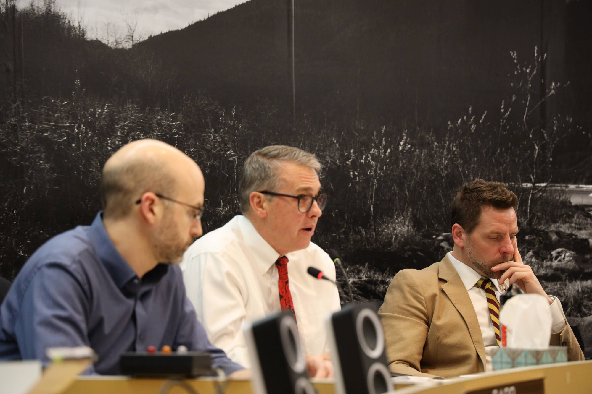 From left to right, City and Borough of Juneau Deputy City Manager Robert Barr, City Manager Rorie Watt and Finance Director Jeff Rogers discuss a package of proposals addressing recruiting and retaining city employees during the Wednesday evening Assembly Finance Committee meeting. (Clarise Larson / Juneau Empire)