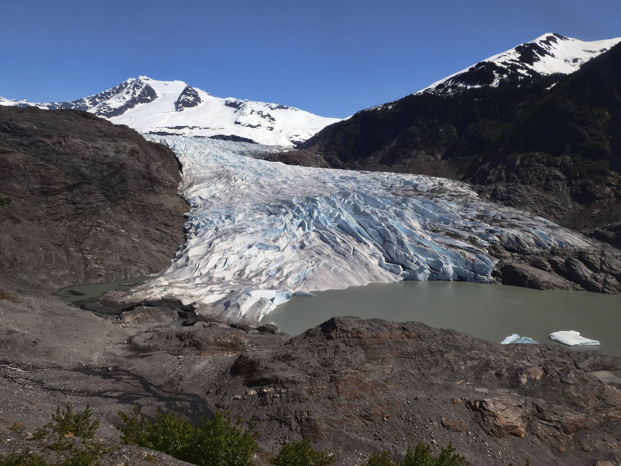 Chunks of ice float on Mendenhall Lake in front of the Mendenhall Glacier on Monday, May 30, 2022, in Juneau, Alaska. A study of all of the world’s 215,000 glaciers published on Thursday, Jan. 5, 2023, finds even if with the unlikely minimum warming of only a few tenths of a degrees more, the world will lose nearly half its glaciers by the end of the century. With the warming we’re now on track to get, the world will lose two-thirds of its glaciers and overall glacier mass will drop by one-third while sea level rises 4.5 inches just from melting glaciers. (AP Photo / Becky Bohrer)